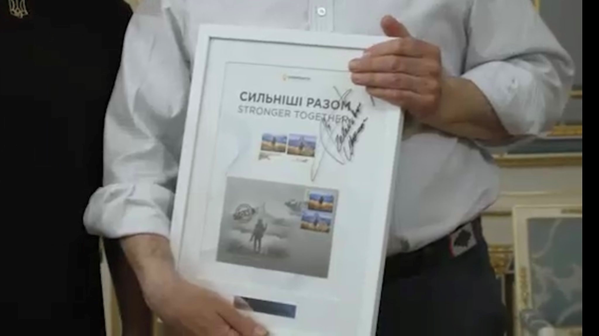 Defence Secretary Ben Wallace holding signed framed collection of 'Russian warship, go f yourself stamps from President Zelenskyy' 10062022 CREDIT Zelenskyy Telegram,AP Ukraine.jpg