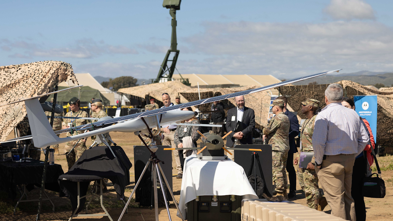 Defence industry partners and military personnel walk around the multiple stands on display at Project Convergence 4 (Picture: British Army).