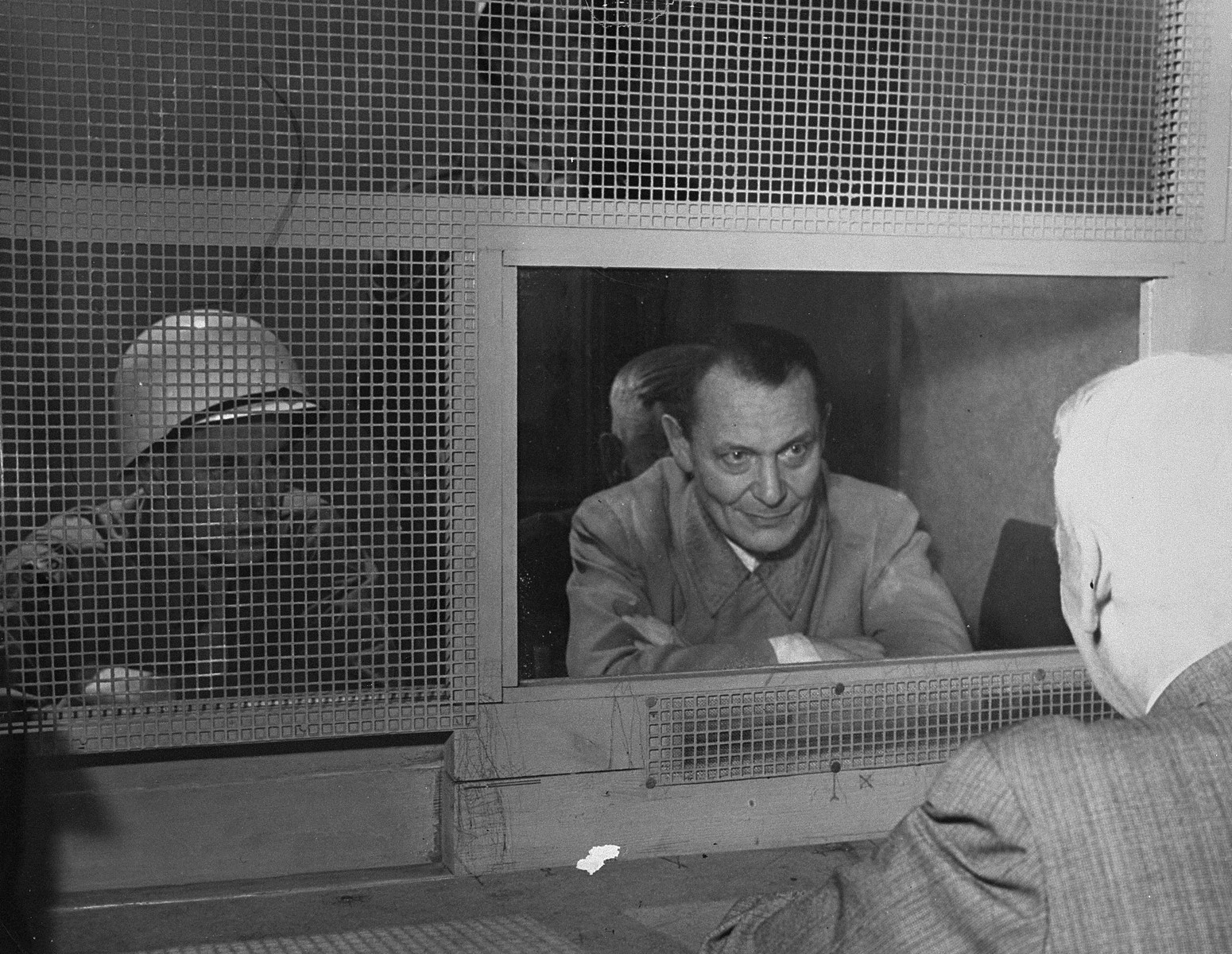 Defendant Hermann Goering consults with his lawyer, Dr. Otto Stahmer, in the Nuremberg prison.