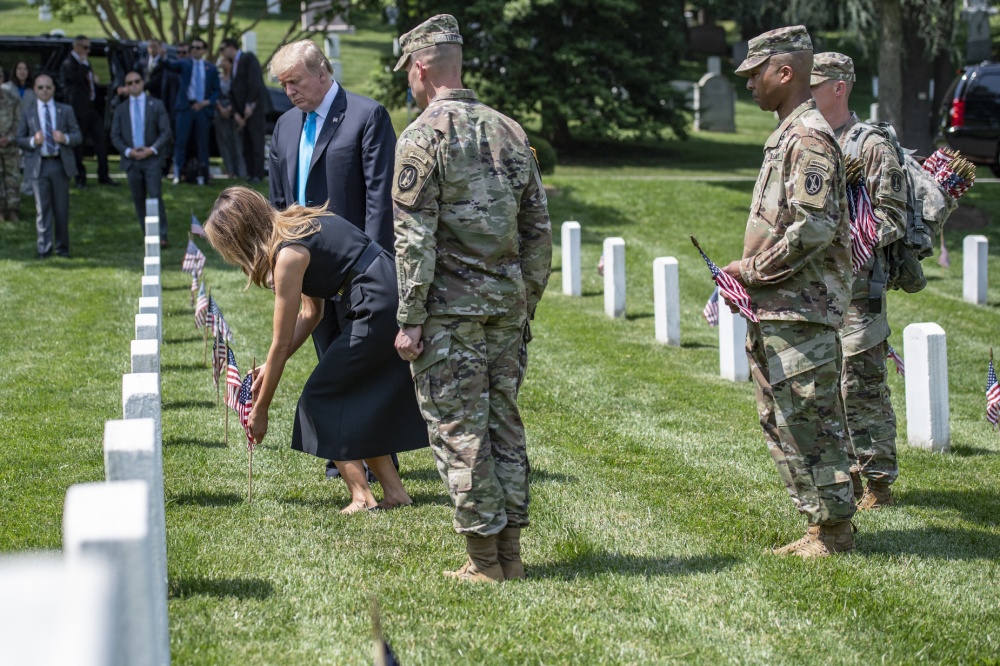 Donald Trump and Melania Trump place flags at Arlington cemetery headstones