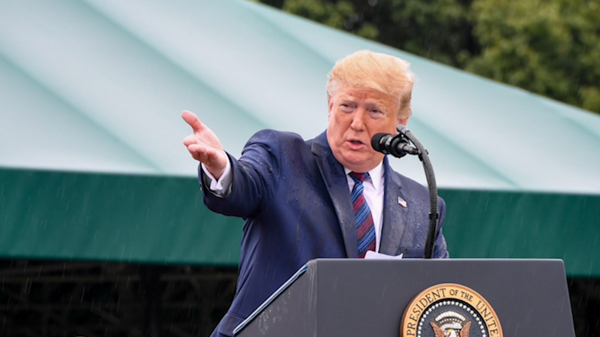 Donald Trump gesturing while standing at podium