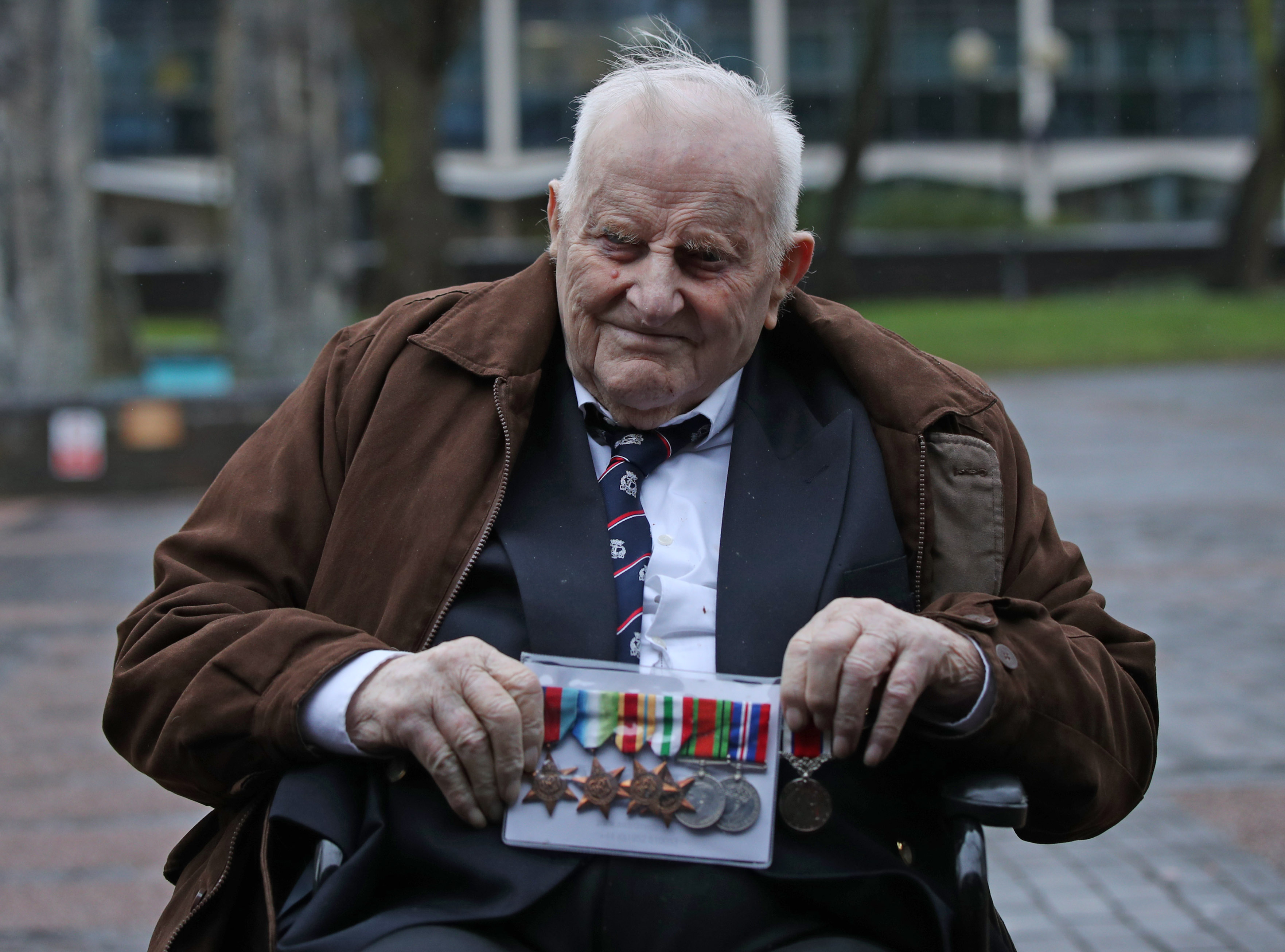97-year-old veteran Douglas Meyers outside court with his medals