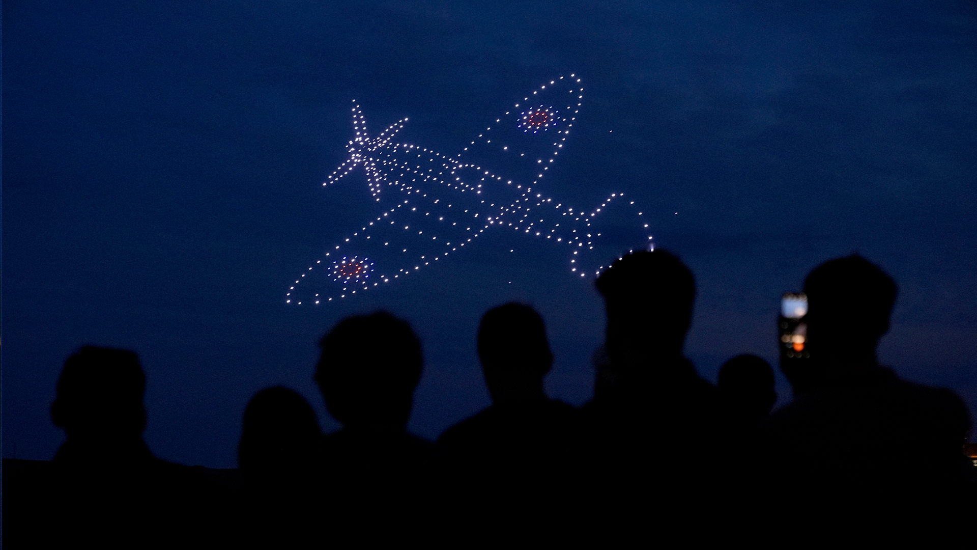 Drones make a Spitfire during a drone display telling the story of D-Day above the coastline in Portsmouth 050624 CREDIT PA