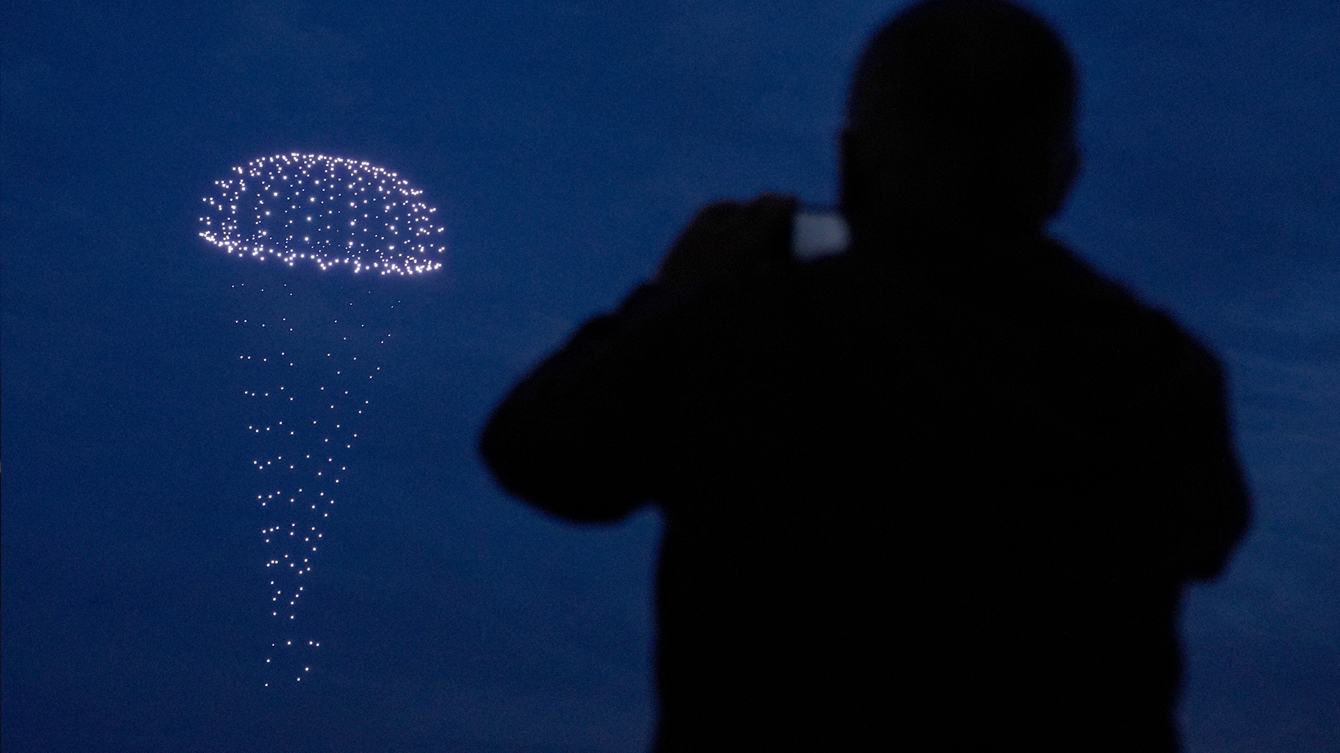 Drones make a parachute during a drone display telling the story of D-Day above the coastline in Portsmouth 050624 CREDIT PA.png