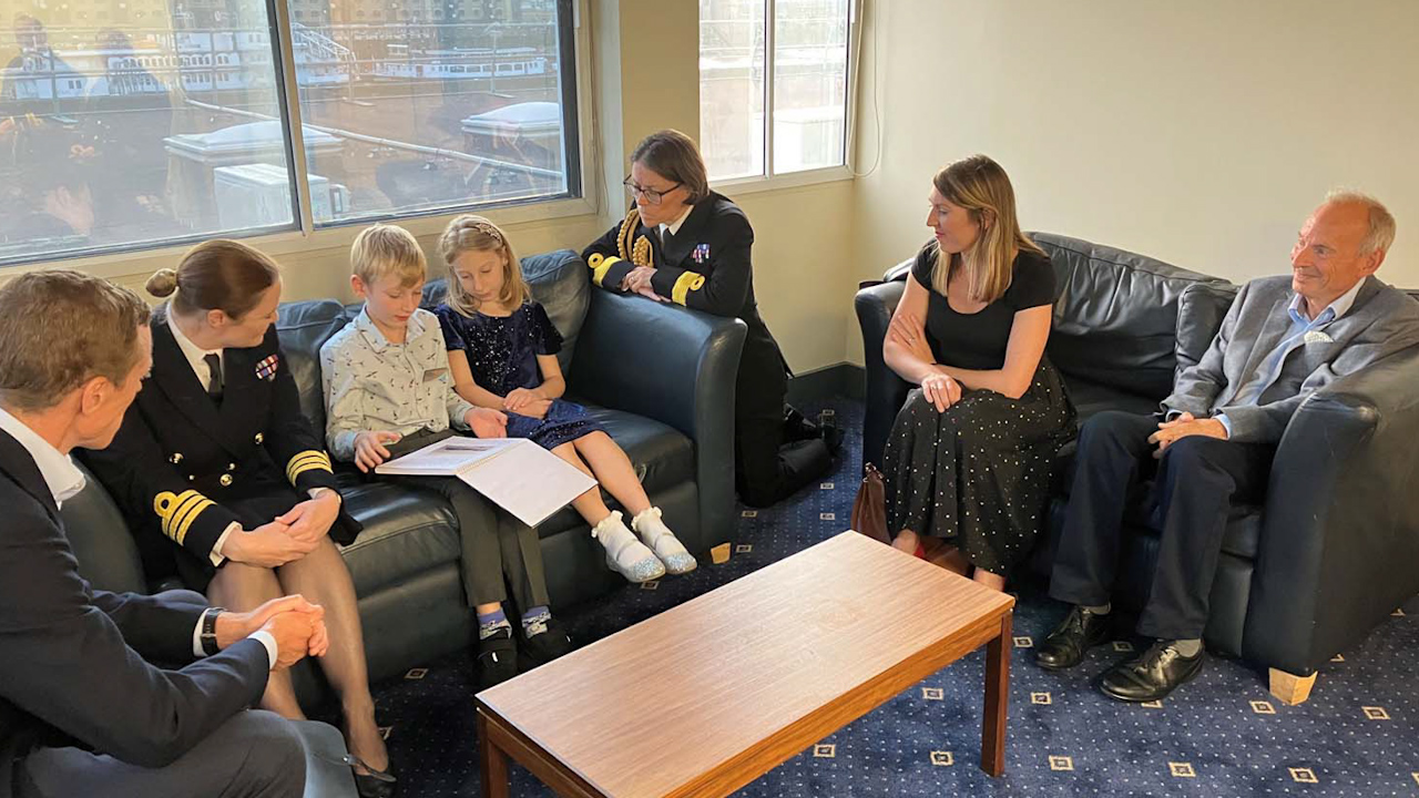 Edward and Alice showing their research to Commodore Jo Adey and Commander Laura Harrison (Picture: Royal Navy).