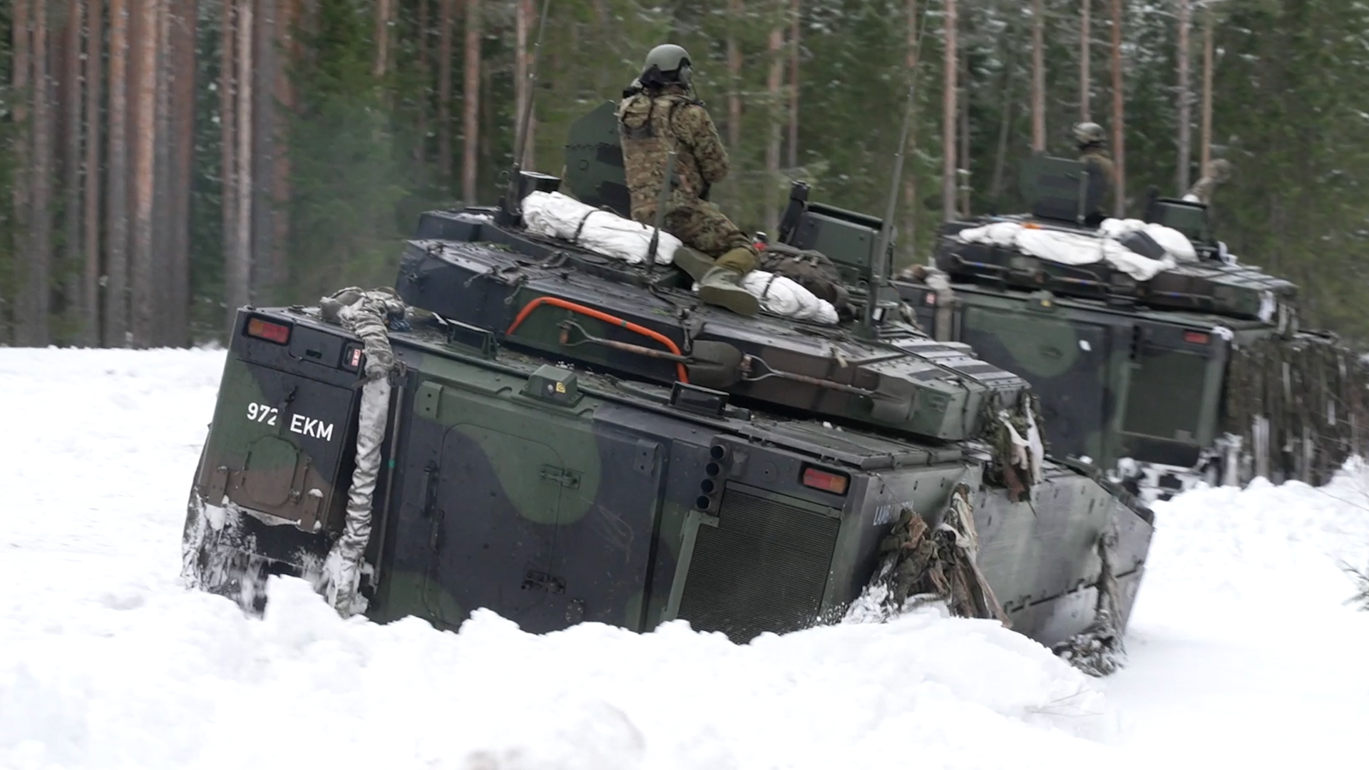 A CV90 ploughs through snow in Estonia on Exercise Winter Camp in 2022