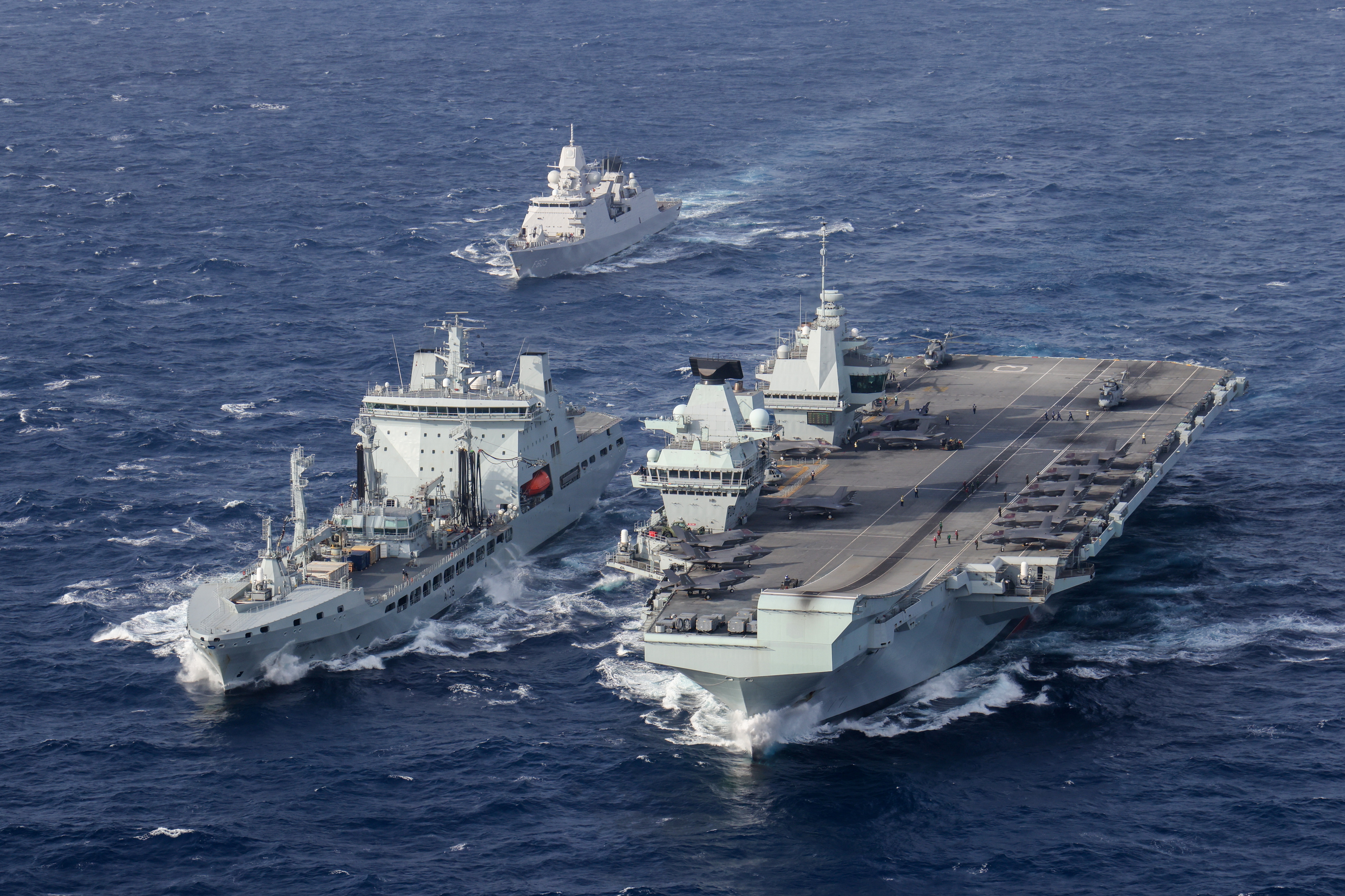 HNLMS Evertsen approaches RFA Tidespring and HMS Queen Elizabeth to conduct a double replenishment at sea.