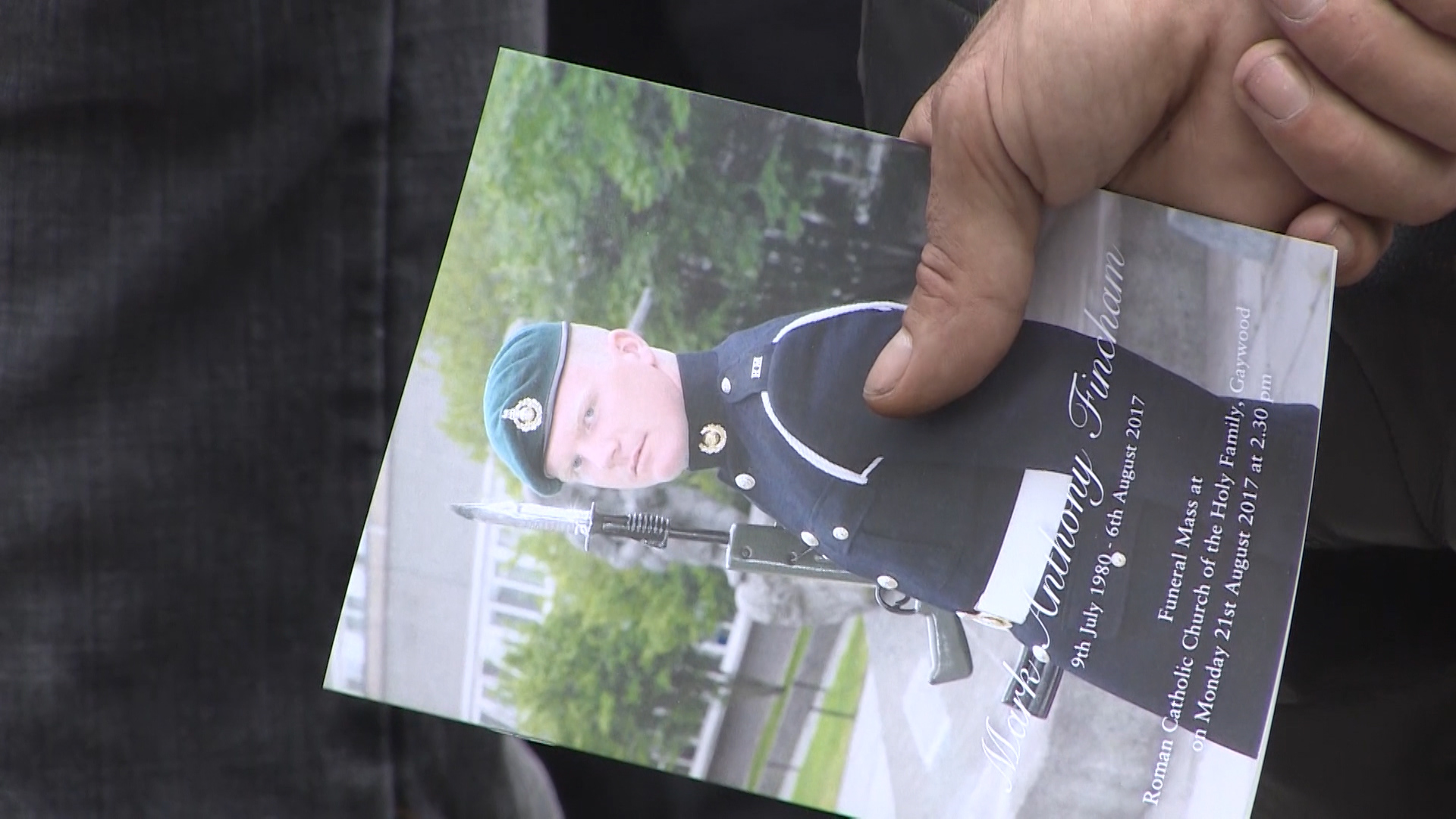 Mourner with Mark Fincham funeral card