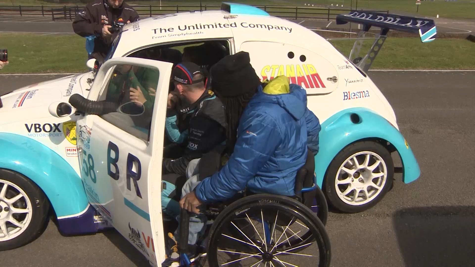 Ade Adepitan inspects Team Brit race car