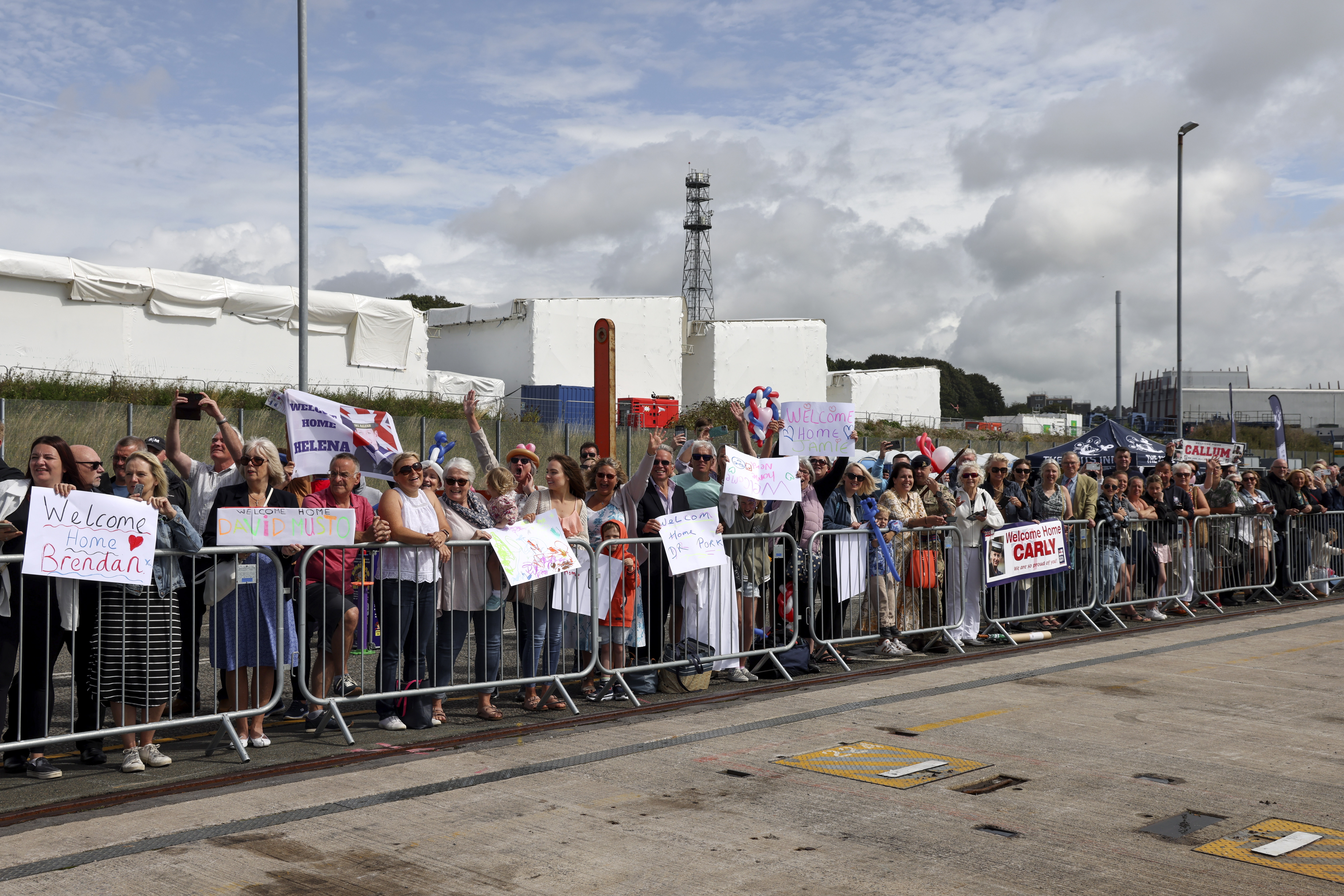Families of HMS Northumberland greet their loved ones on the jetty at HMNB Devonport