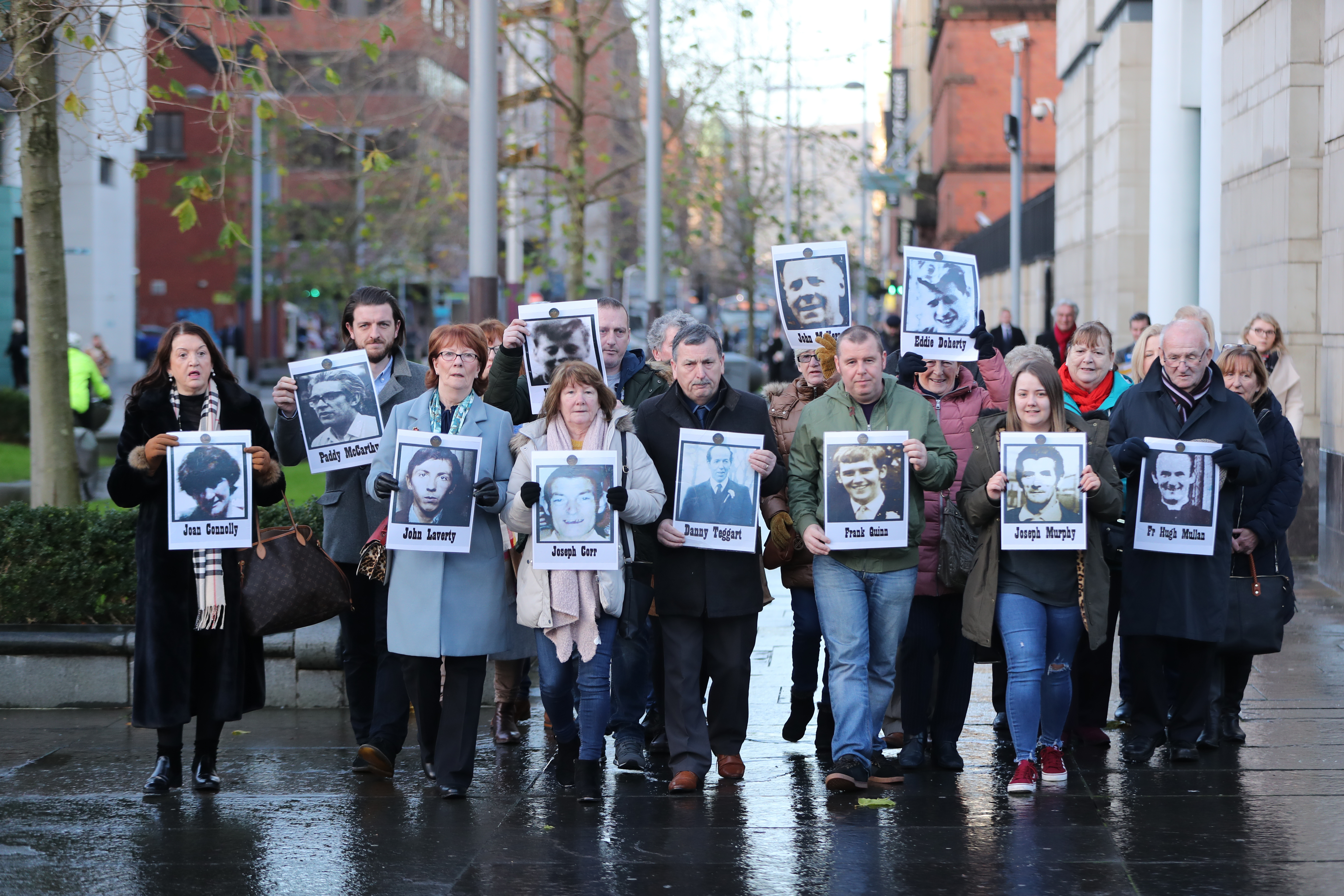 Family members outside Laganside Courts in Belfast hold images of some of those who were killed in disputed circumstances over the course of three days 091219 CREDIT PA.jpg
