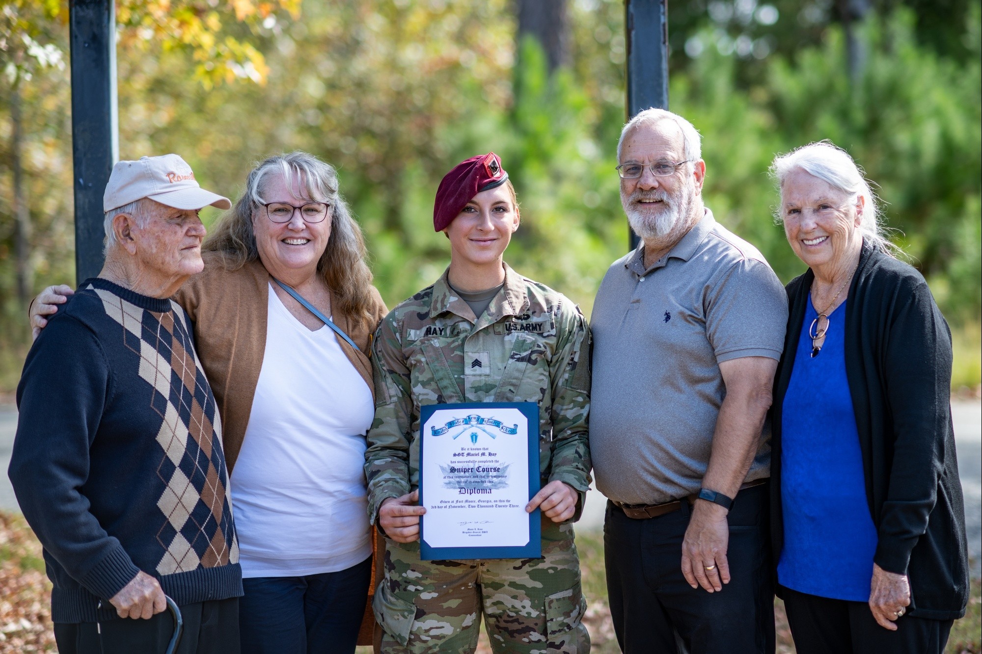 First active duty female US Army sniper Sgt Maciel Hay poses with her family after graduating CREDIT US Army
