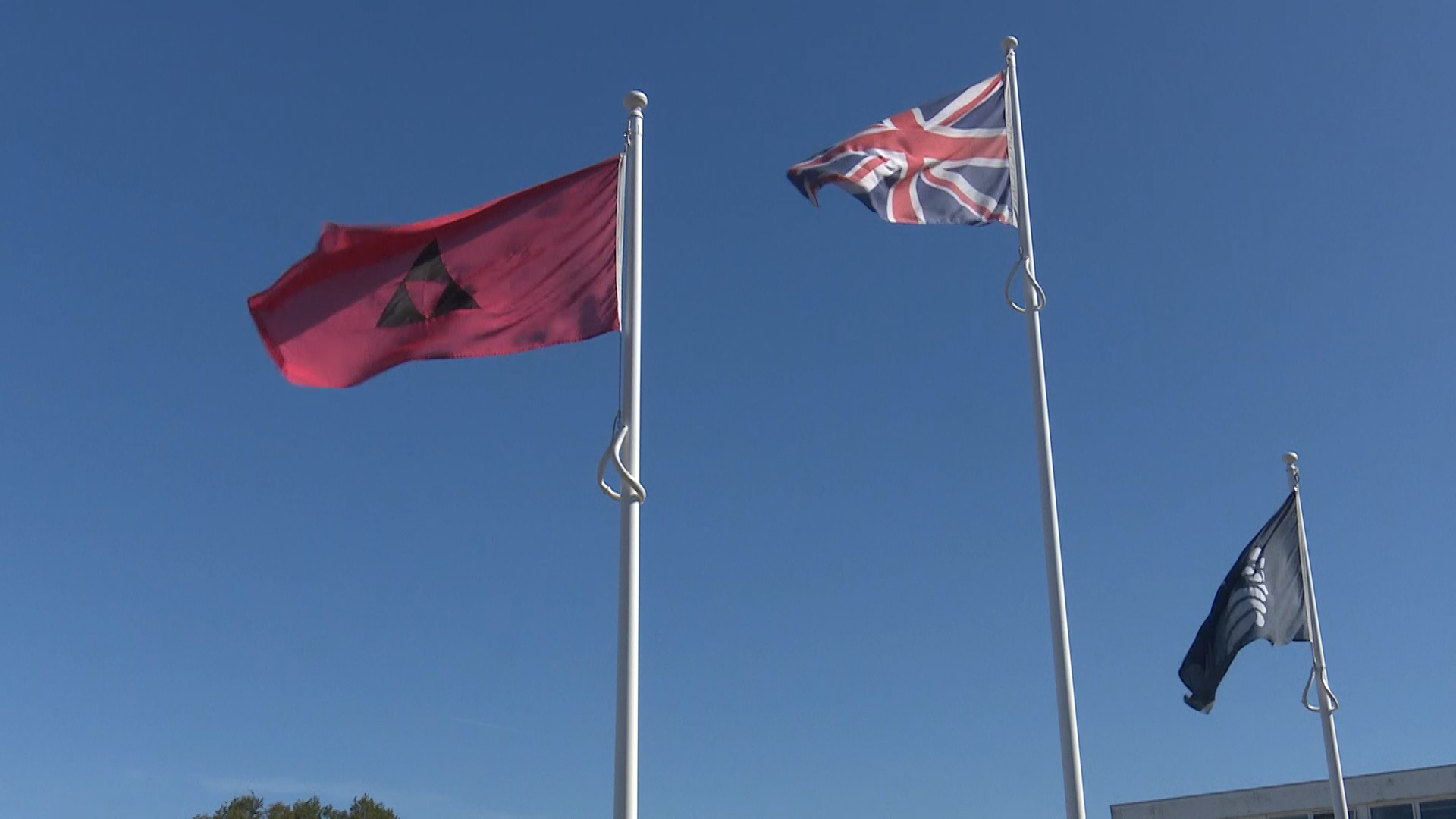 Flags are raised outside the new headquarters.