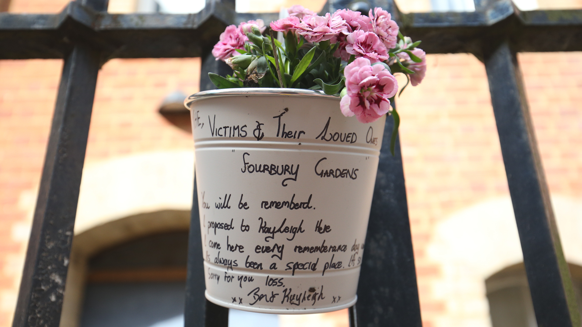 Flowers and a message left at the Abbey gateway of Forbury Gardens in Reading town centre following a multiple stabbing attack 210620 CREDIT PA.jpg
