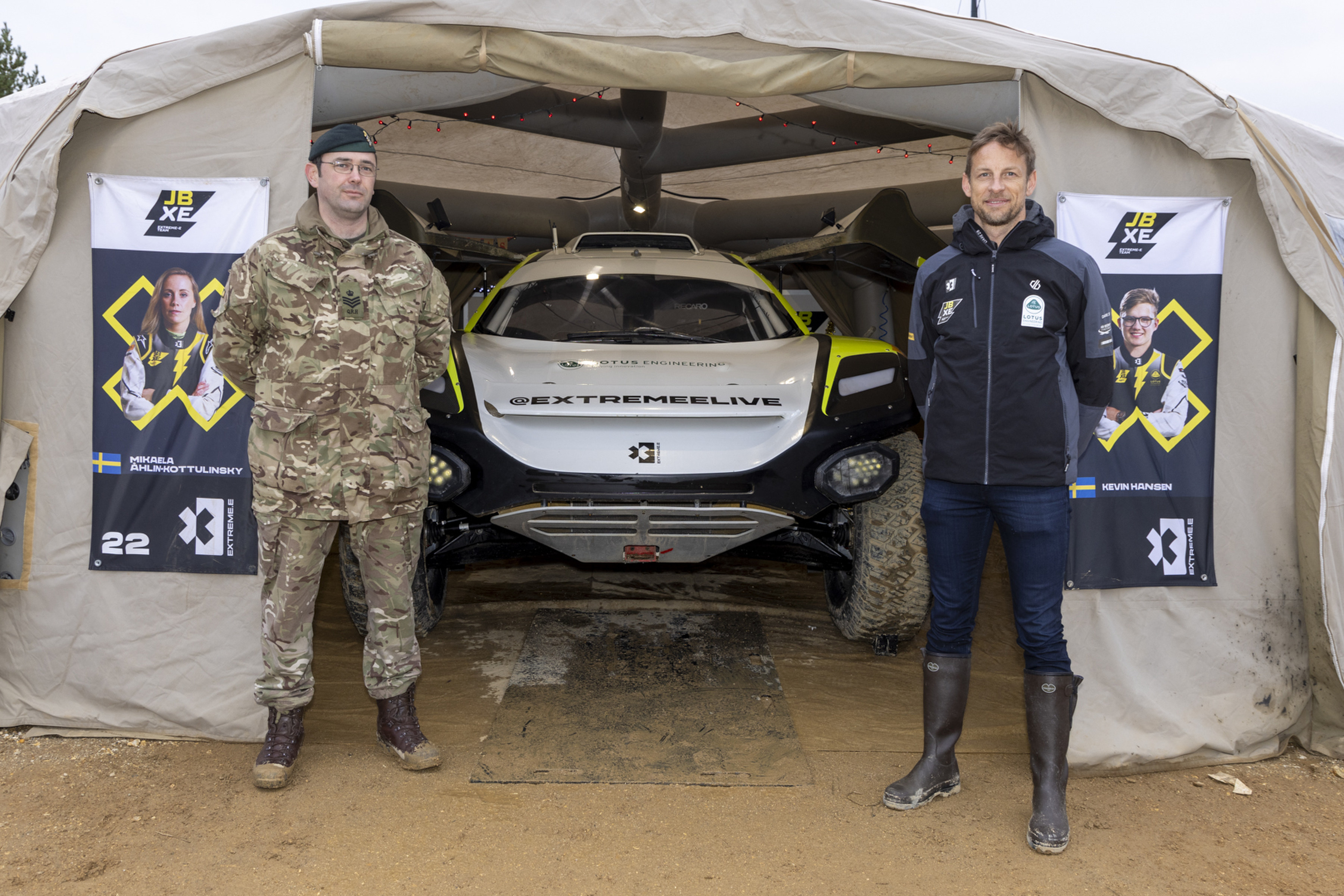 Former F1 World Champion Jenson Button standing with Staff Sergeant Ben De Ronde REME, outside Jenson’s team tent at the Extreme E off road race series (Picture: MOD).
