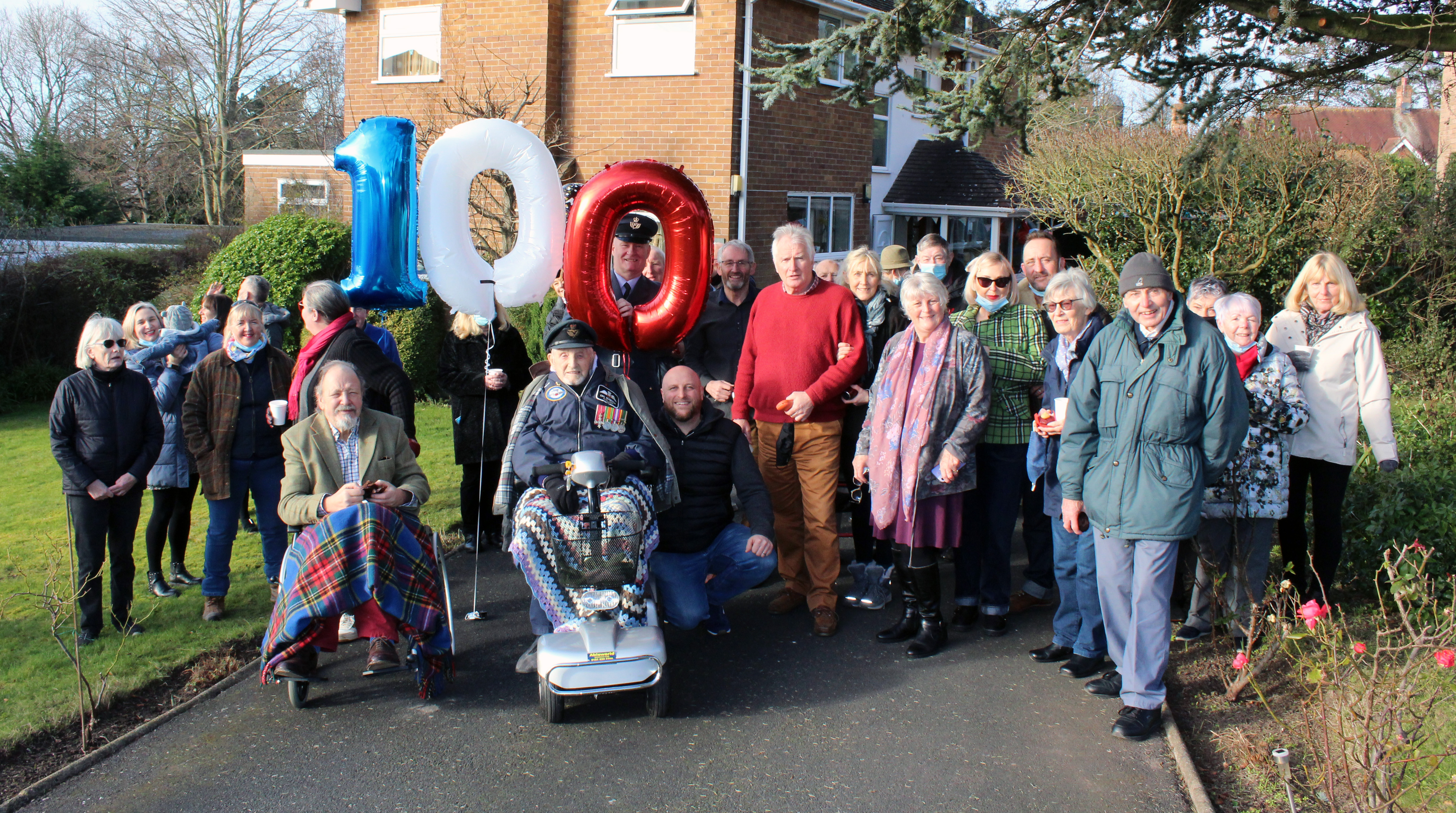 Former Squadron Leader Eric Robinson OBE with family, friends and members of 611 Squadron celebrating his 100th birthday