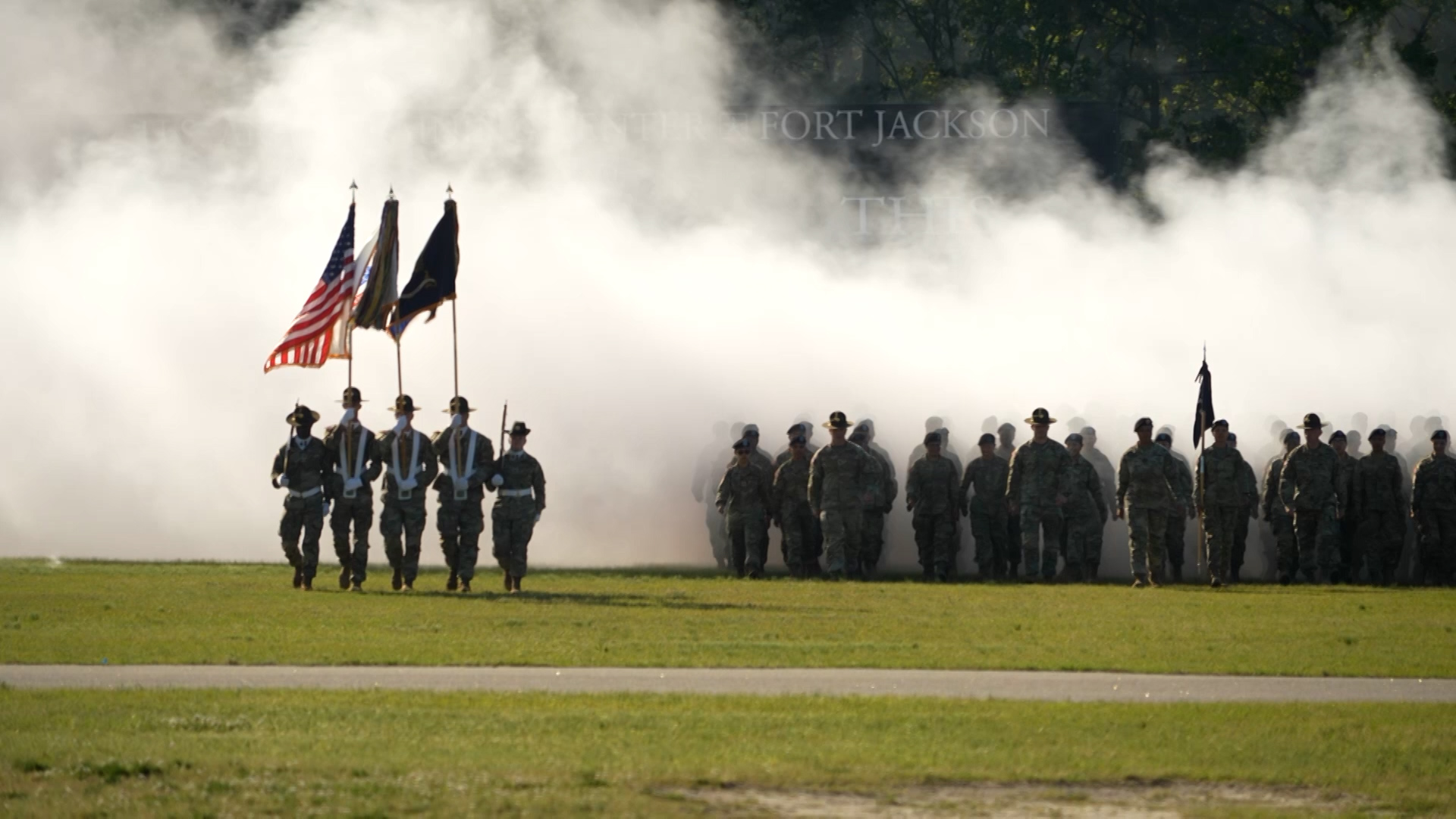 Fort Jackson recruits emerging from the smoke on their family day.