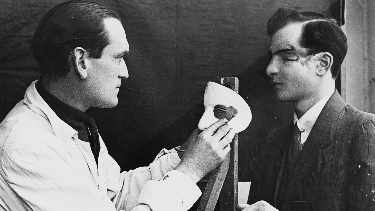 Cover Image: Francis Derwent Wood moulding plates for prosthetics during the First World War (Picture: Chronicle / Alamy Stock Photo).