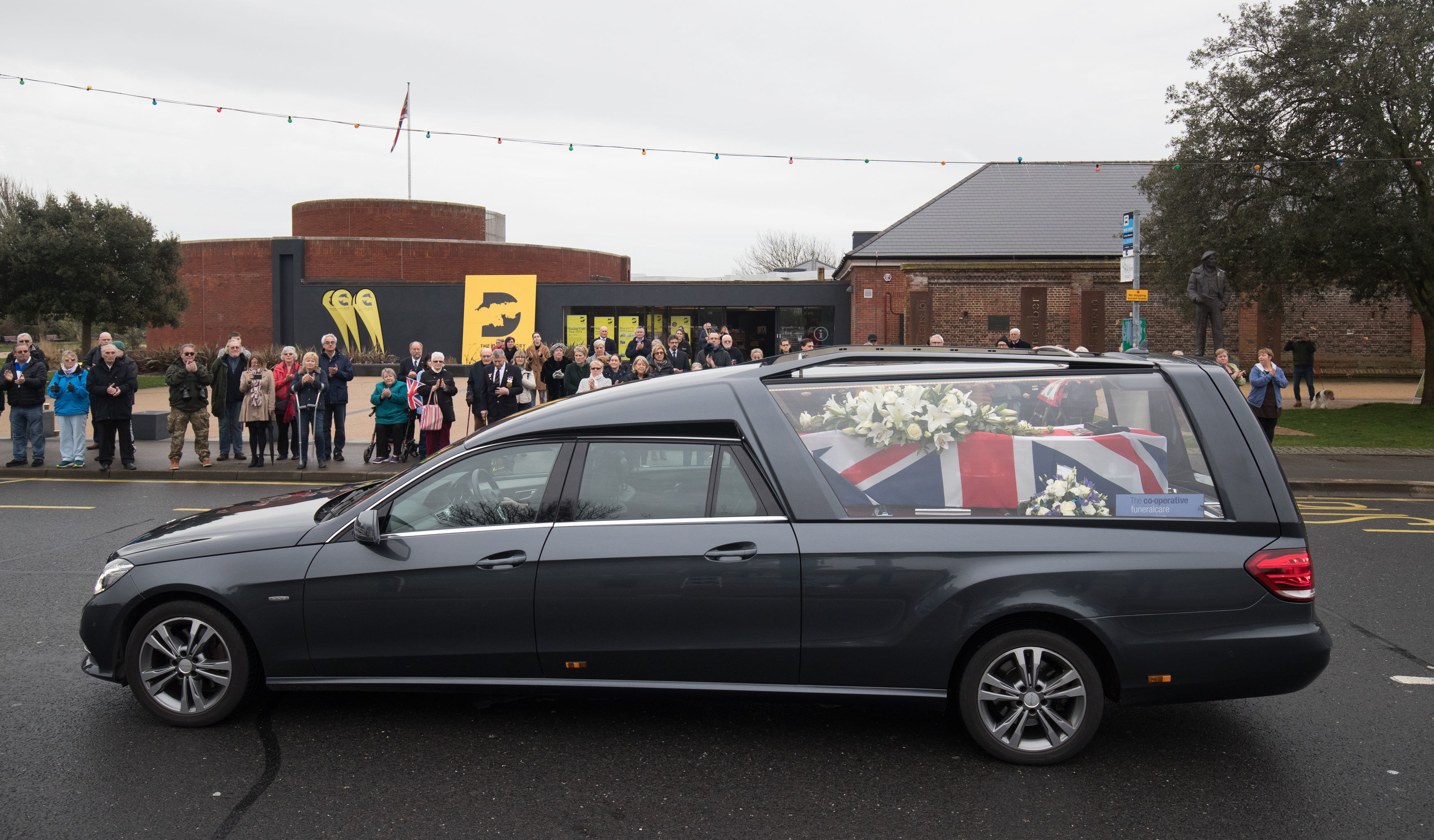 Cover Image: More than 100 people watched the funeral procession (Picture: PA).