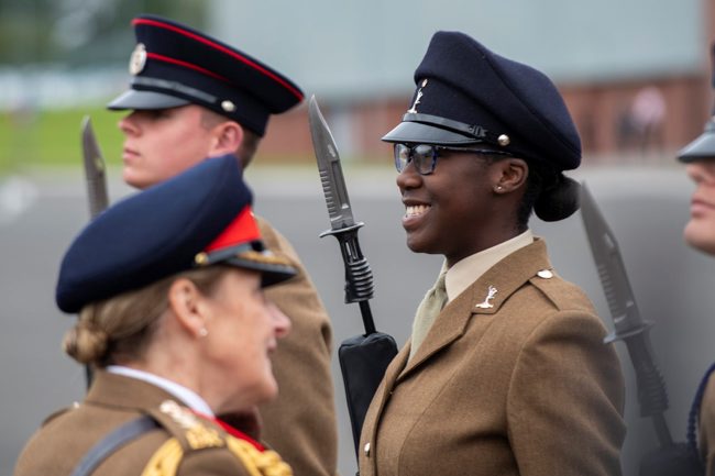Male and female trainee British soldiers on the parade ground