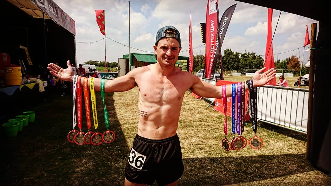 Jon poses with his medals from the Great Barrow Challenge