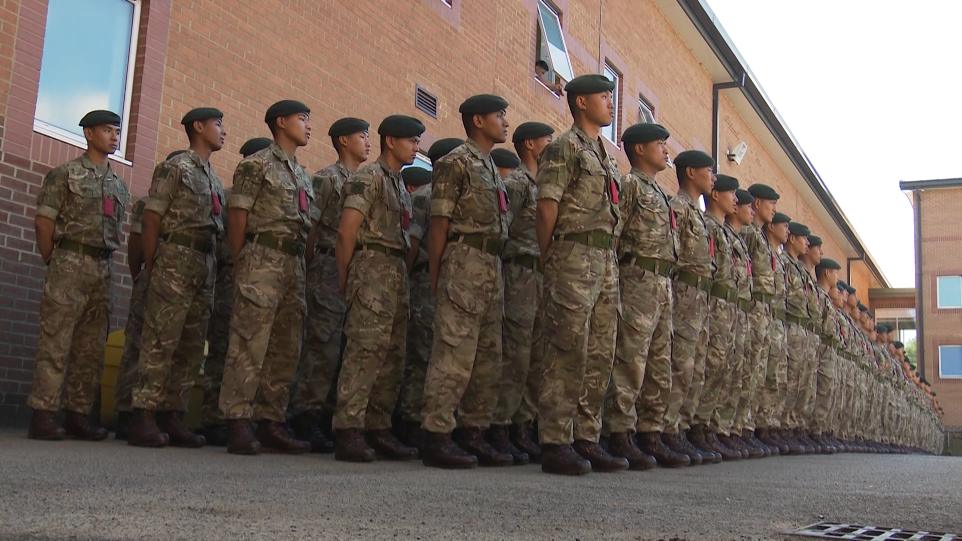 Gurkha recruits line up for cap badging.