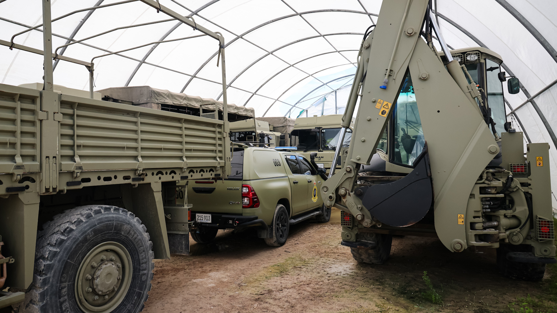 Diggers and support vehicles are proving their worth in the clean-up operation (Picture: MOD)