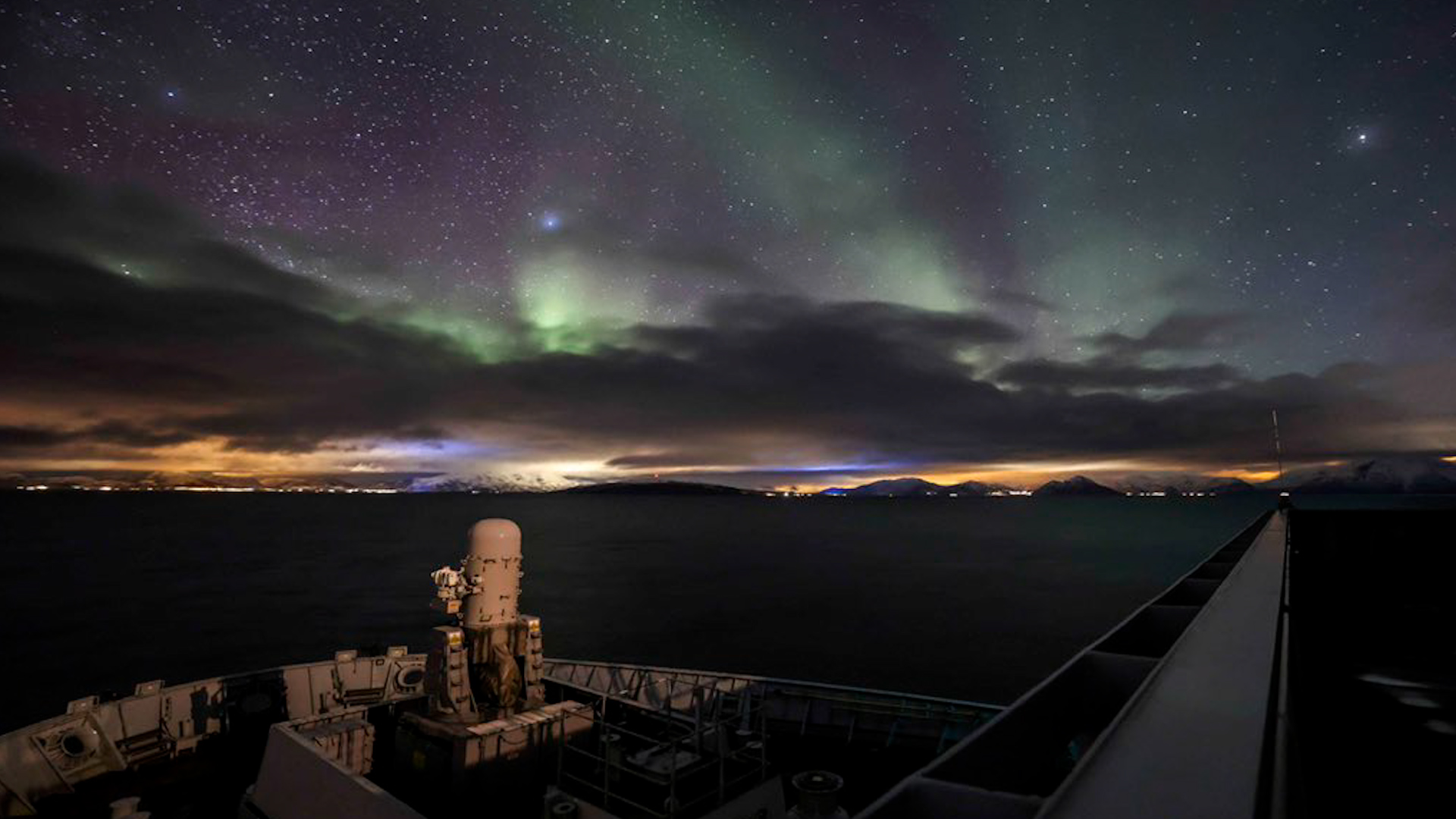 HMS Albion with the northern lights in the background as it prepares for Exercise Cold Response (Picture: HMS Albion/Twitter).