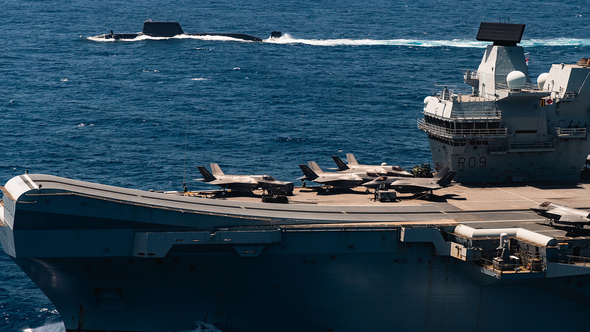 HMS Astute sails alongside HMS Prince of Wales on Operation Highmast