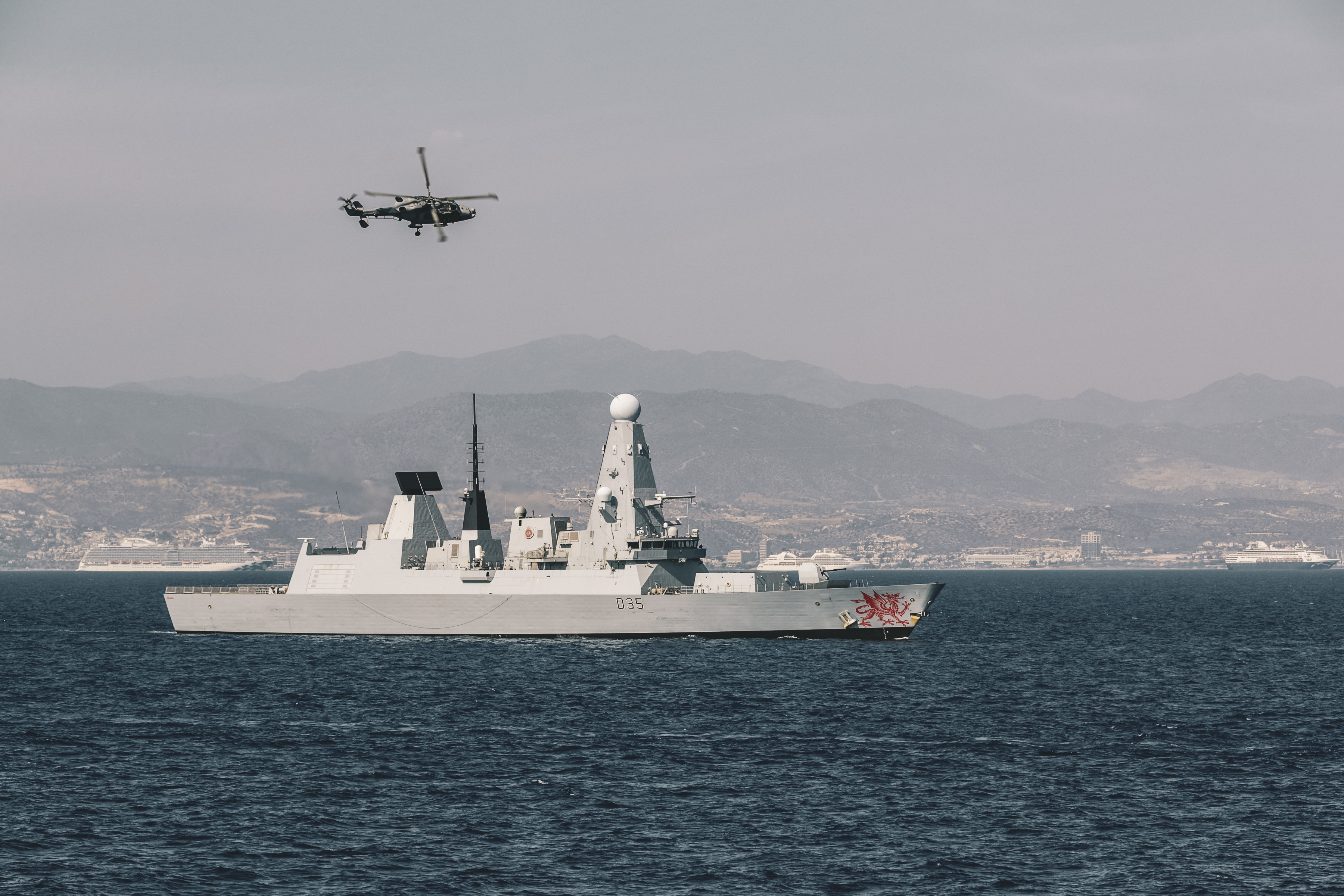 HMS Dragon with a Wildcat helicopter flying overhead during an exercise in Cyprus which aims to shape the Future Commando Force 261020 CREDIT MOD