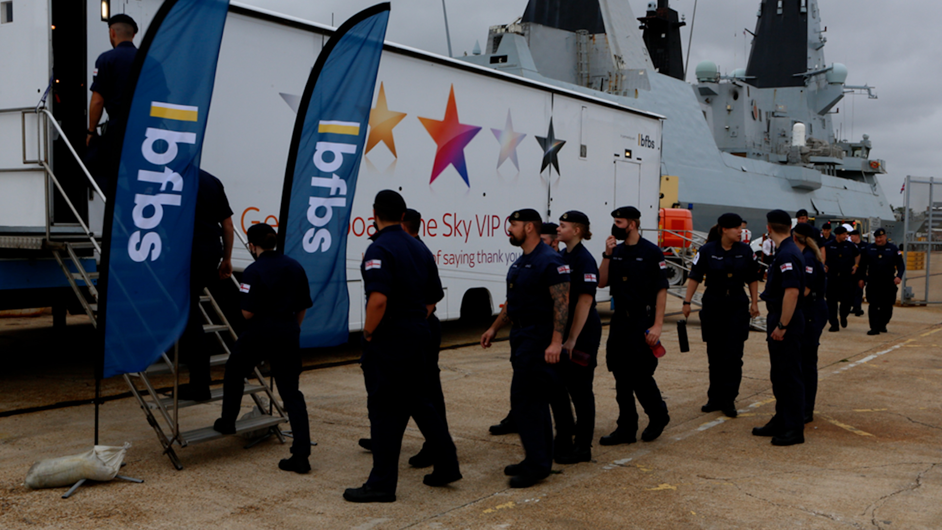 HMS Dragon's crew and their families go to a special viewing of the new James Bond film at BFBS Cinemas' Movie Machine
