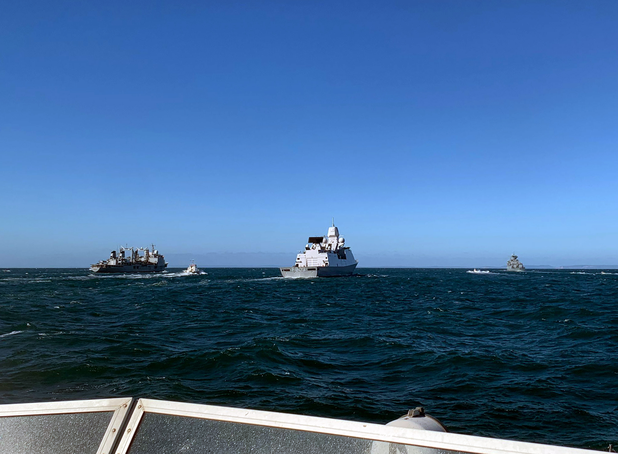 HMS Exploit approaches the task group from astern during Exercise Joint Warrior