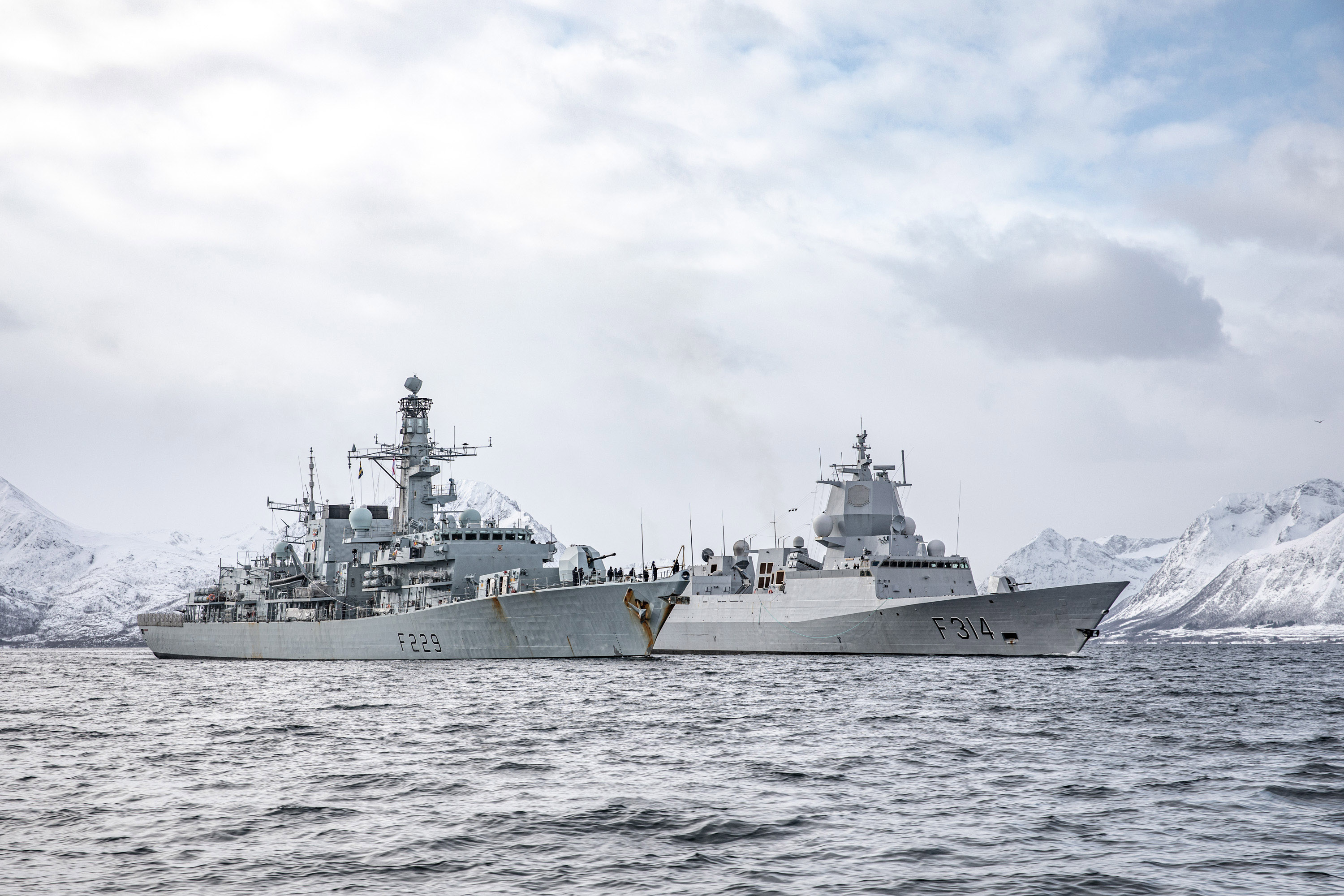 HMS Lancaster (left) and HNoMS Thor Heyerdahl shelter from Arctic storms (Picture: Royal Navy).