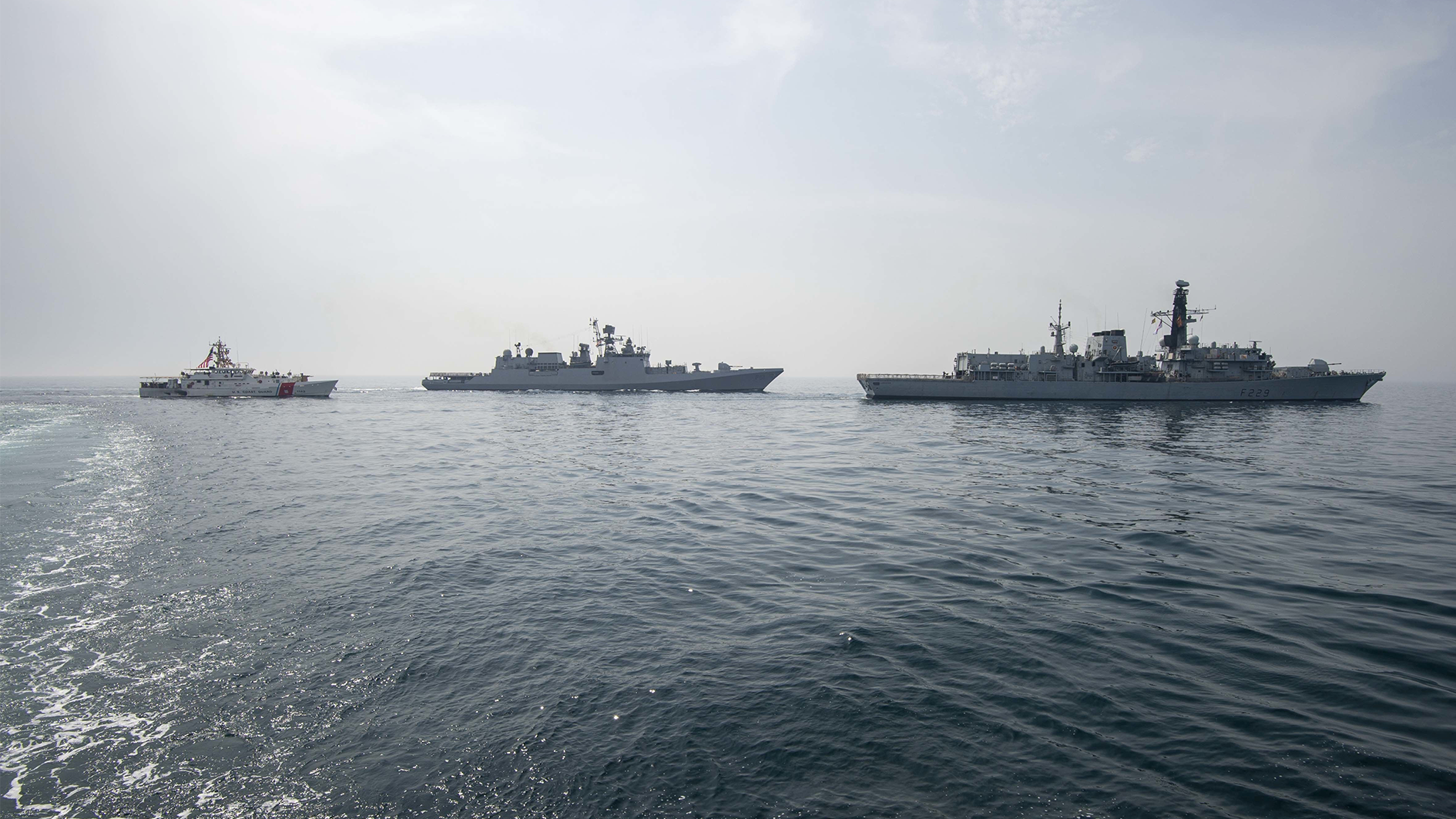 HMS Lancaster leads Indian Navy frigate INS Trikand and US Coast Guard cutter USCGC Robert Goldman