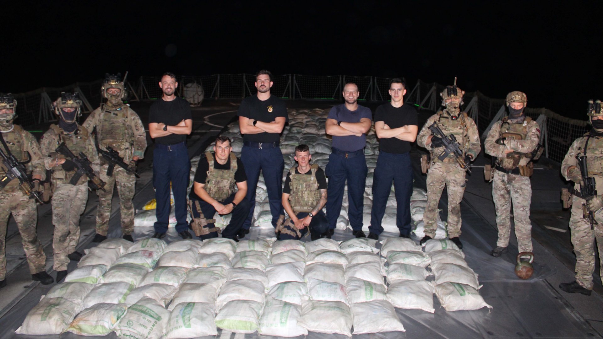 HMS Lancaster's sailors and Royal Marines pose with the haul of hashish after a seizure in the Arabian Sea 110523 CREDIT Royal Navy