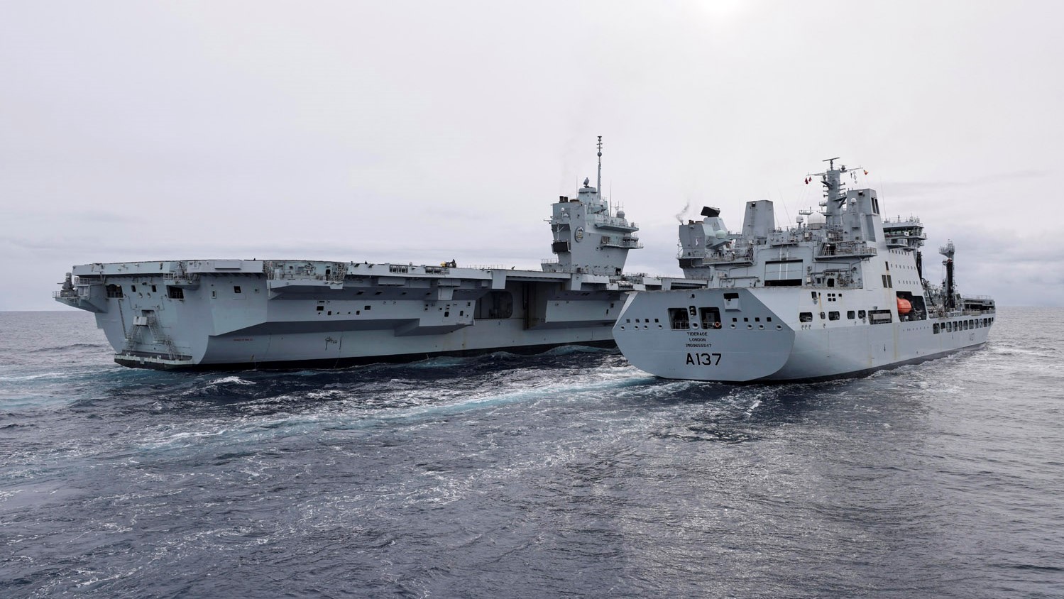HMS Prince of Wales (left) refueling from RFA Tiderace (right) during RAS after leaving Reykjavik Iceland 22042022 CREDIT Royal Navy MOD.jpg