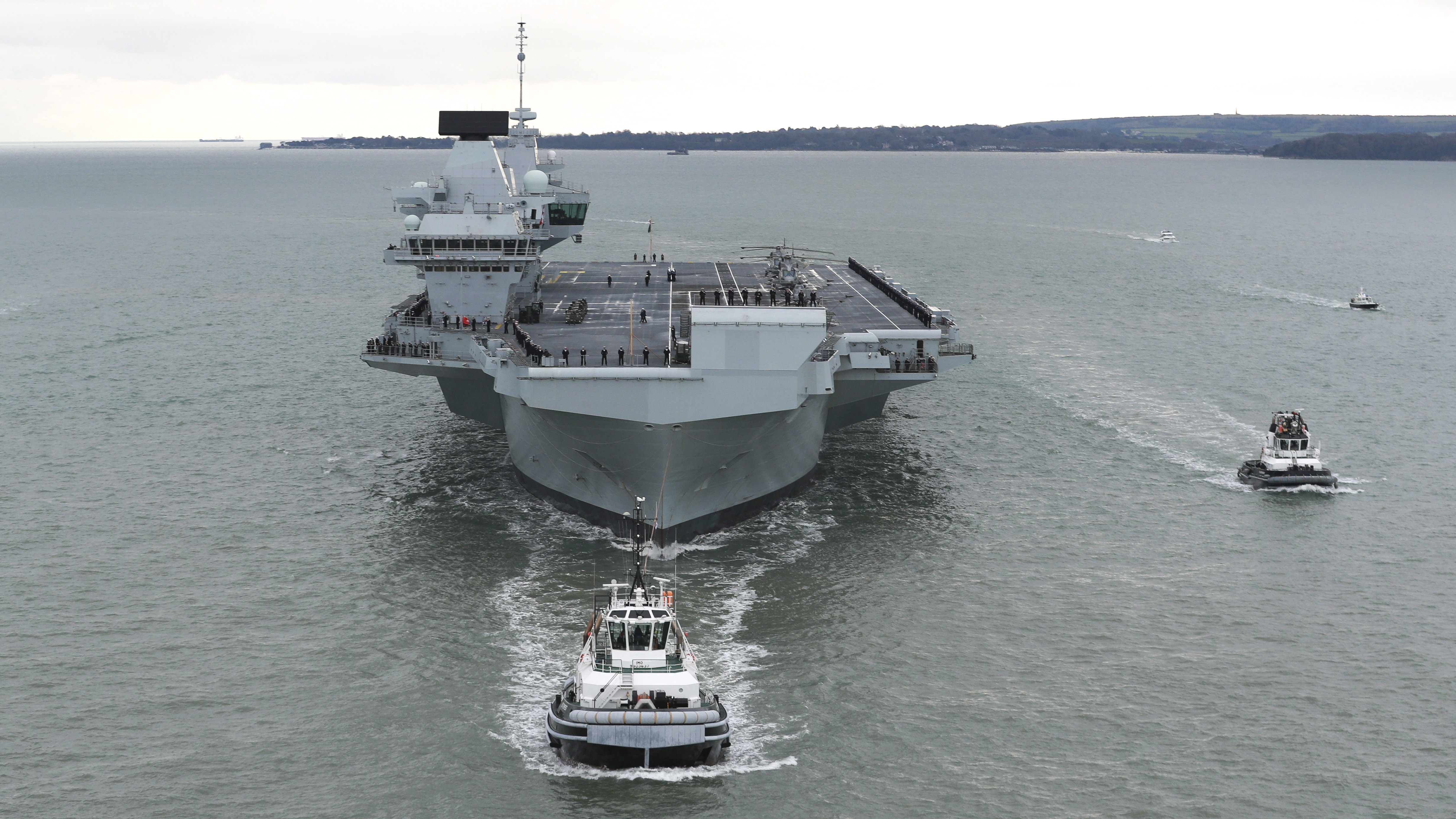 HMS Prince of Wales arriving into Portsmouth for the first time with tug SD Tempest