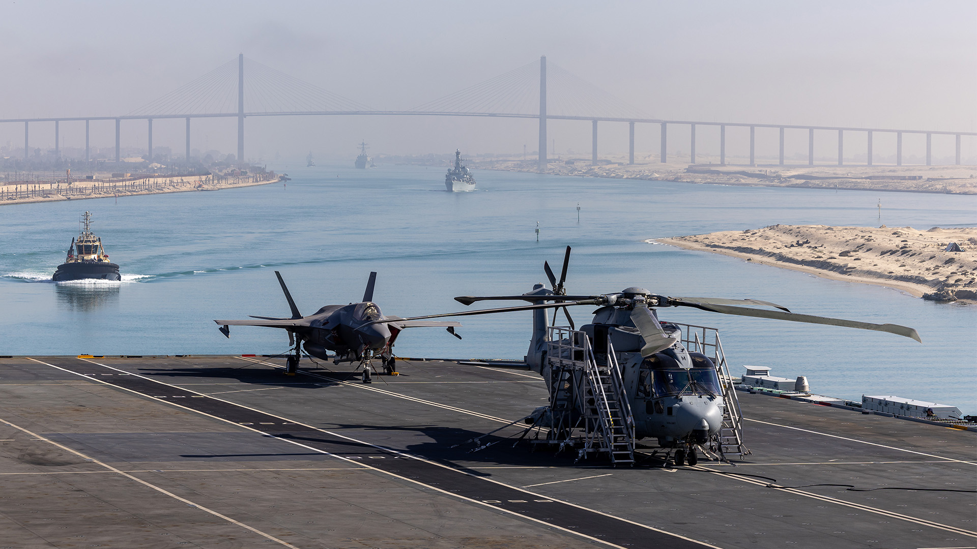 HMS Prince of Wales sailed south under the Al Salam Bridge which crosses the Suez Canal