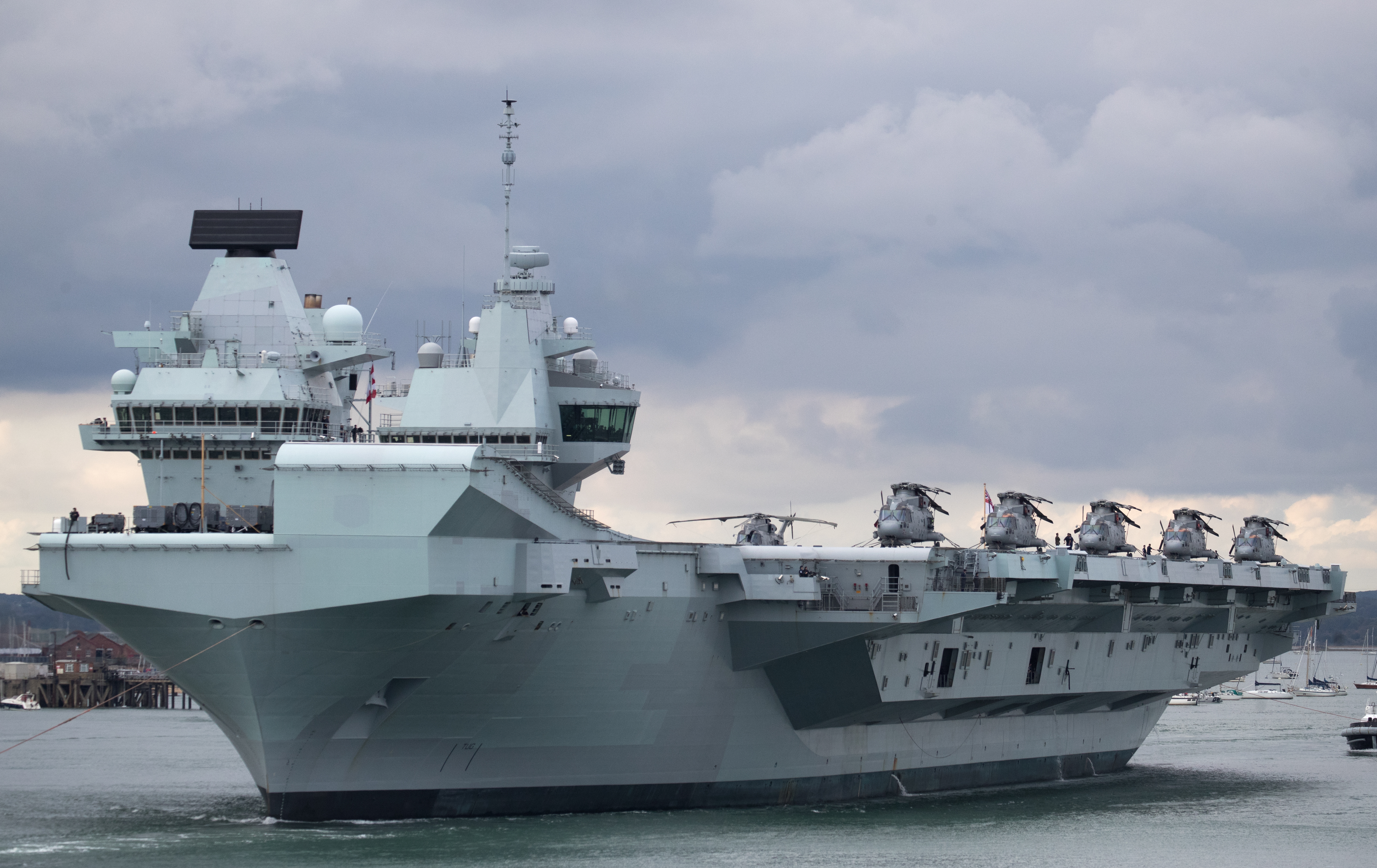 HMS Queen Elizabeth leaving Portsmouth with Merlin helicopters on deck (Picture: PA).