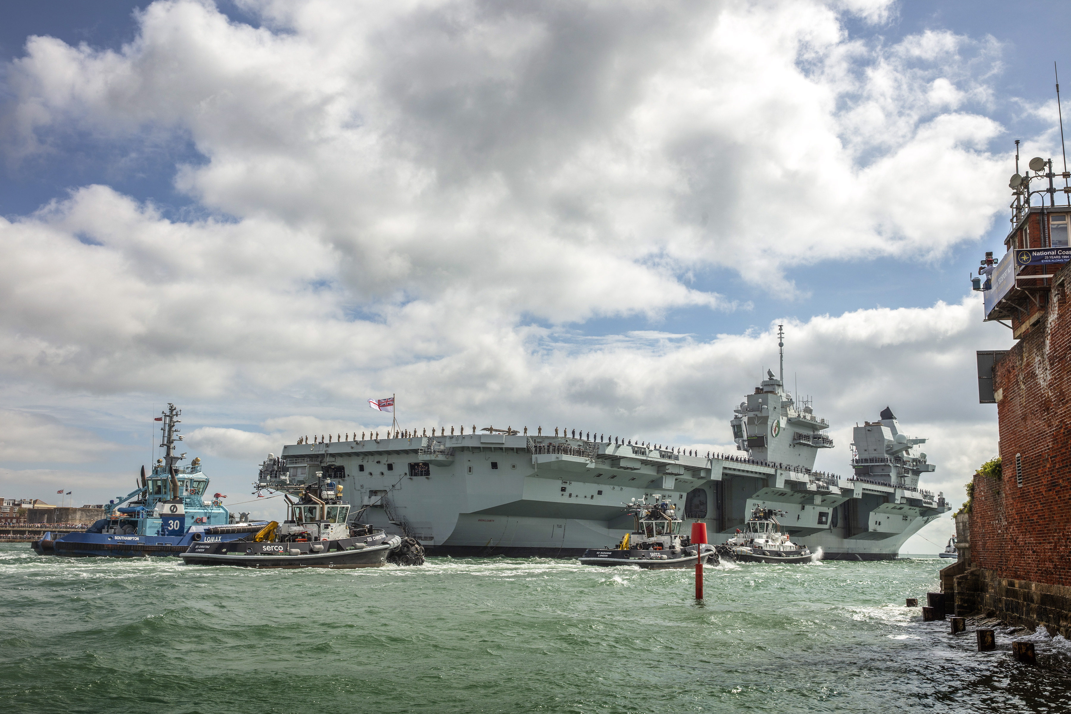 The aircraft carrier passes Portsmouth's city walls (Picture: Royal Navy).