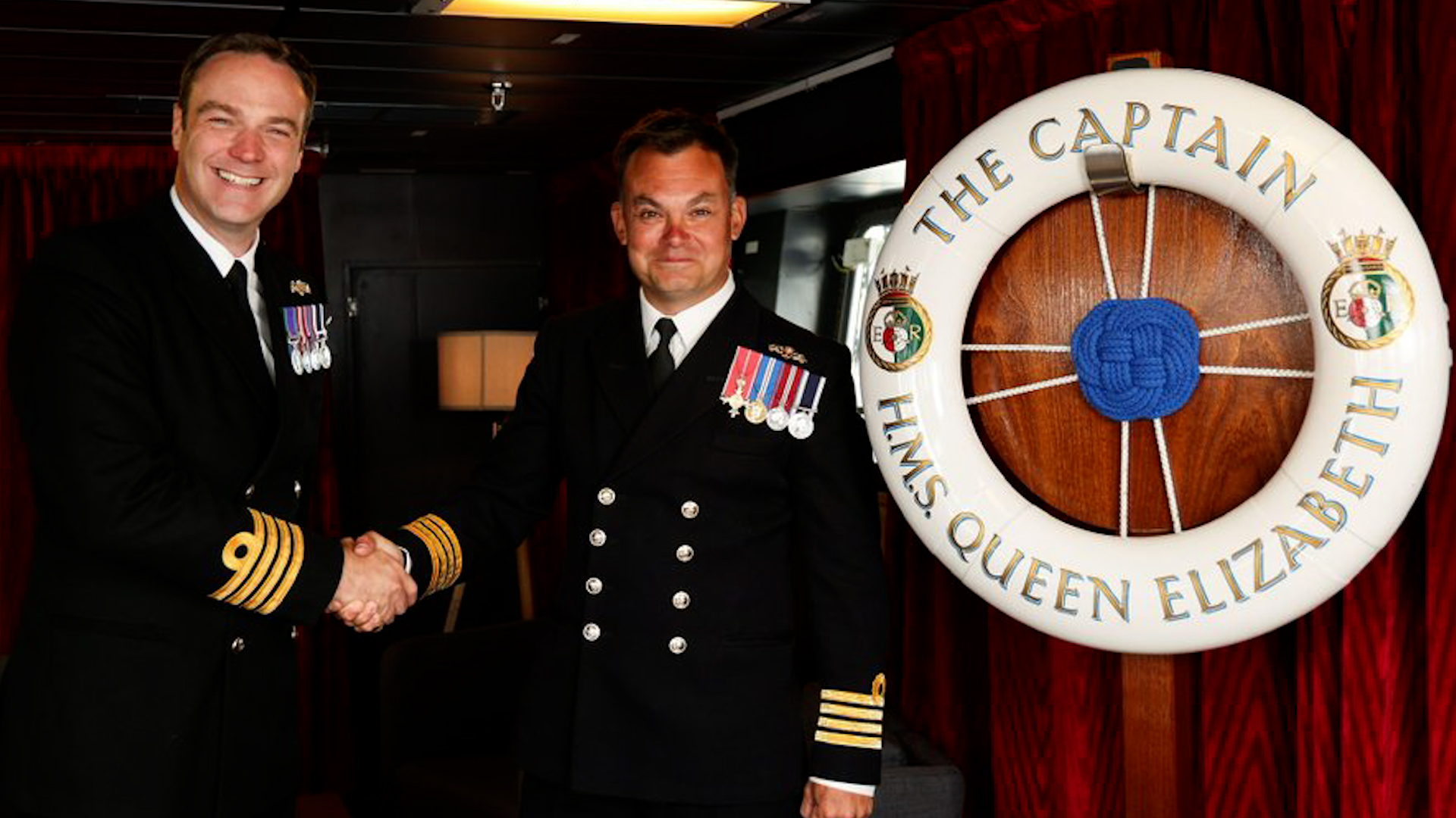 HMS Queen Elizabeth's new Commanding Officer Captain Will King OBE (right), taking over from (left) Captain Ian Feasey