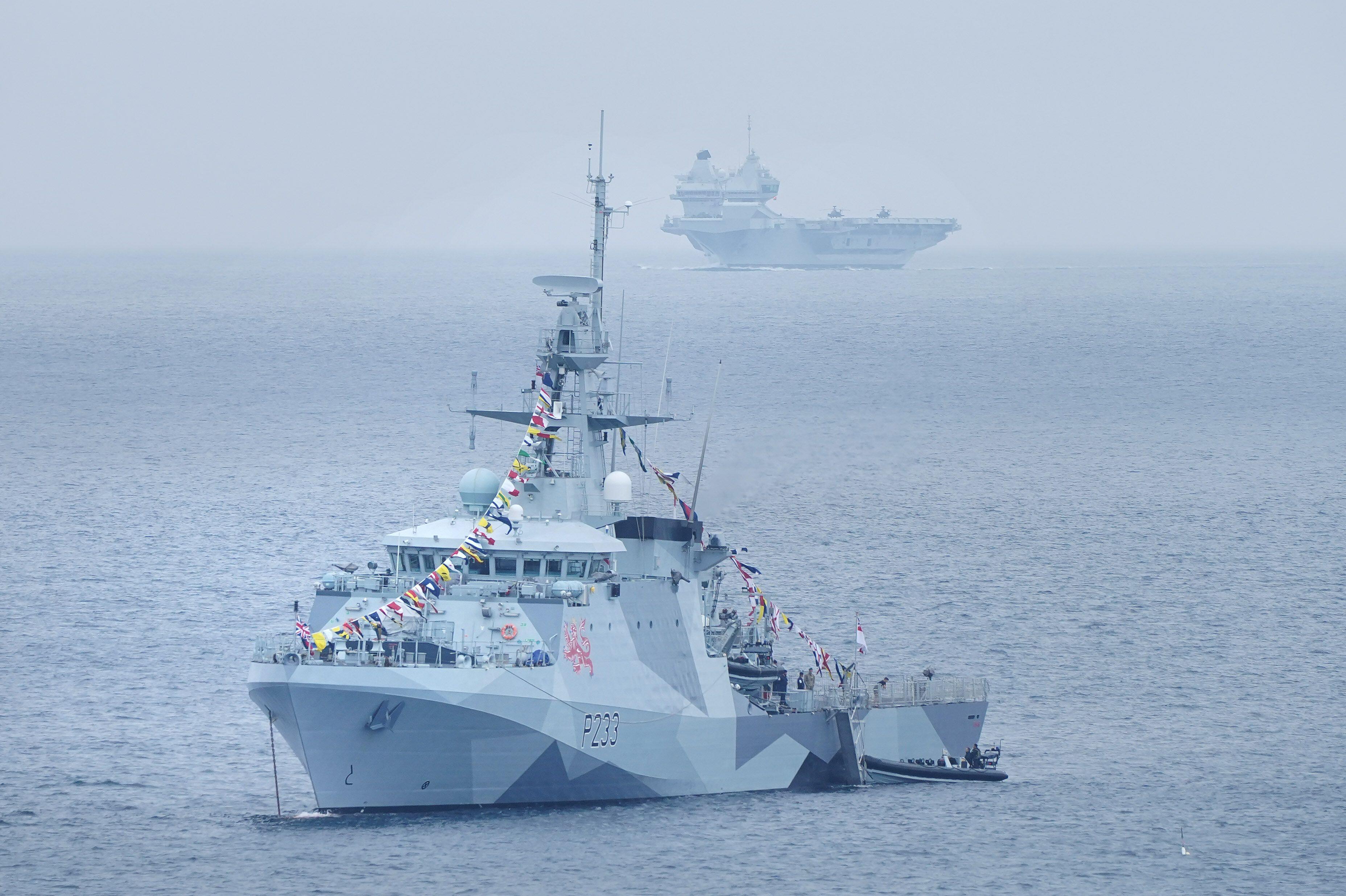 HMS Tamar (front) and HMS Prince of Wales (back) off the coast of St Ives ahead of the summit