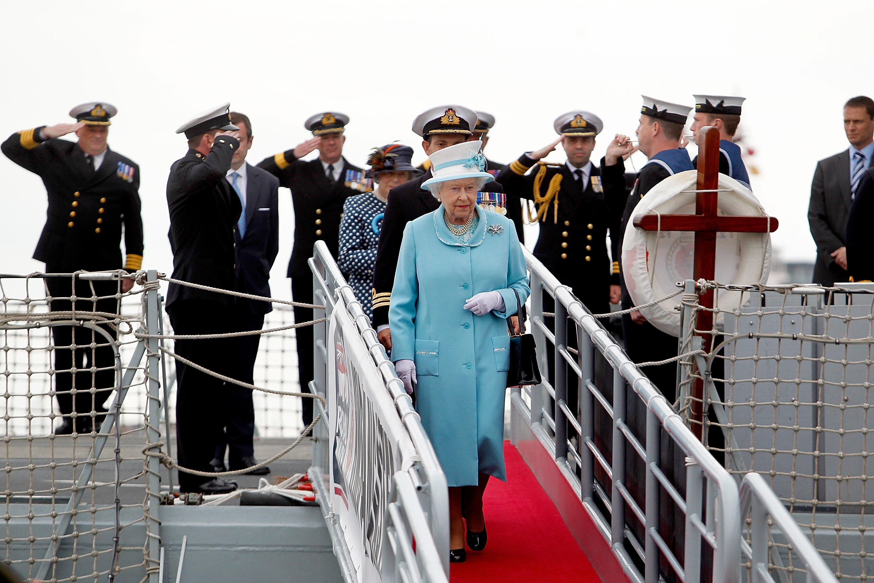 Queen Elizabeth II is saluted by the Officers of HMS Lancaster during a visit to HMS Lancaster at Portsmouth Naval Base (Picture: Alamy).