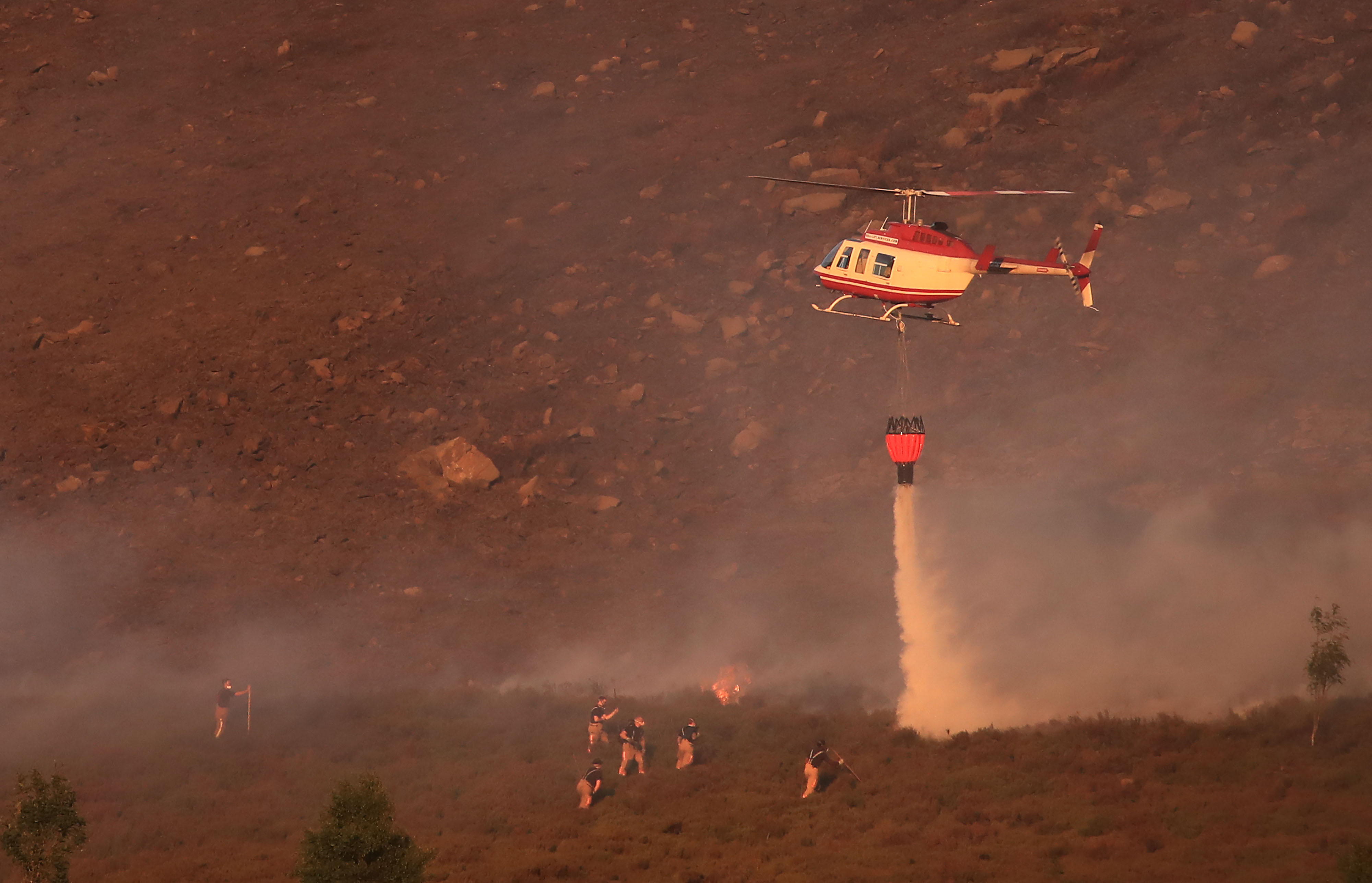 Helicopter dumps water on Saddleworth Moor fire