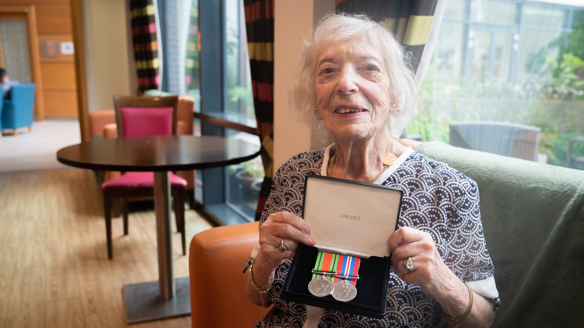Holocaust survivor Henny Franks holds her war medals as she celebrates her 100th birthday at the Jewish Care Holocaust Survivors' Centre, north west London
