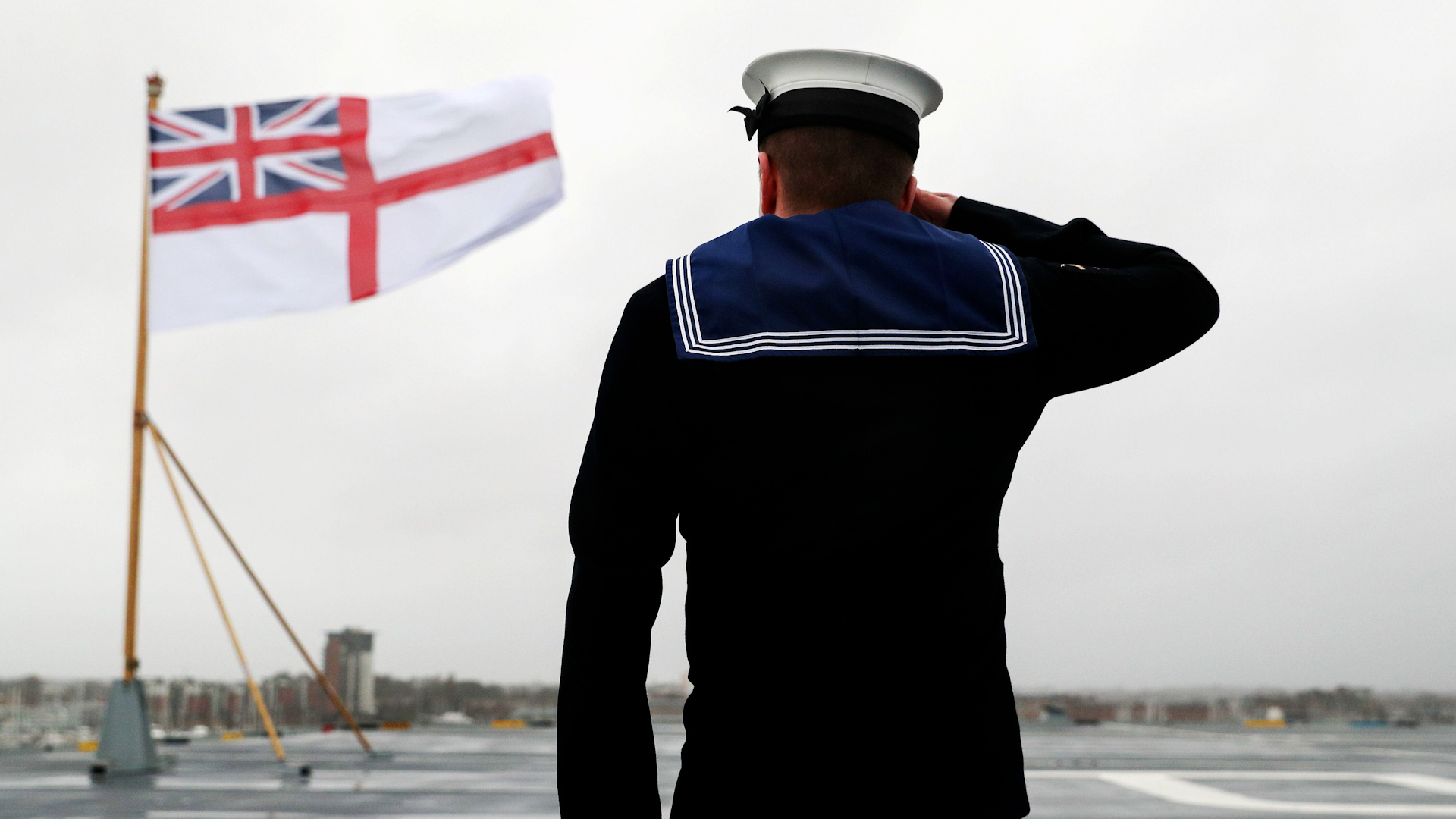 IMAGE ID 2CJ7R29 Semi-anonymous member of Royal Navy salutes White Ensign 101219 CREDIT Andrew Matthews, Pool via Reuters_Alamy Stock Photo.jpg