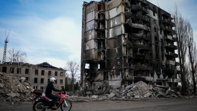 A motorcycle on the road in front of buildings which have been damaged by shelling in central Borodyanka near Kyiv (Picture: Piero Cruciatti/Alamy Live News).