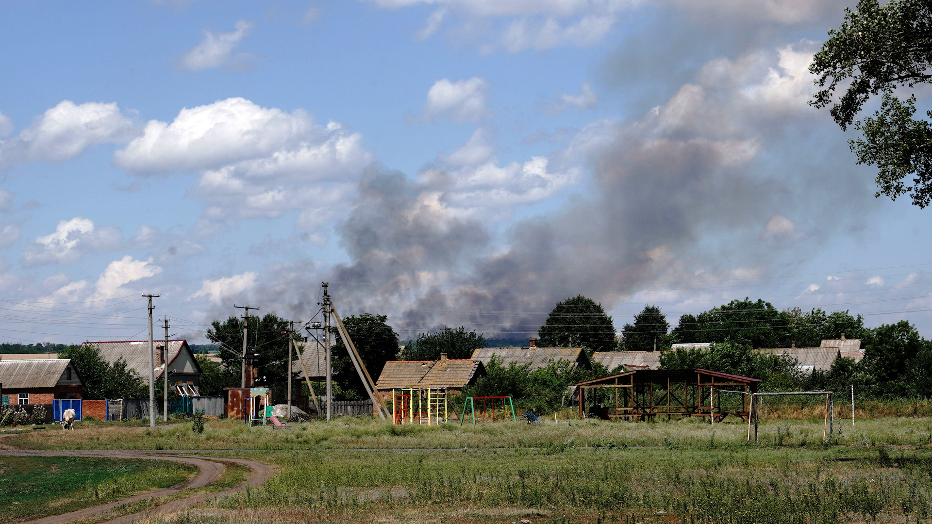 Smoke caused by the shelling of Russian troops rises from behind the houses, Donetsk Region, eastern Ukraine (Picture: Ukrinform/Alamy Stock Photo).