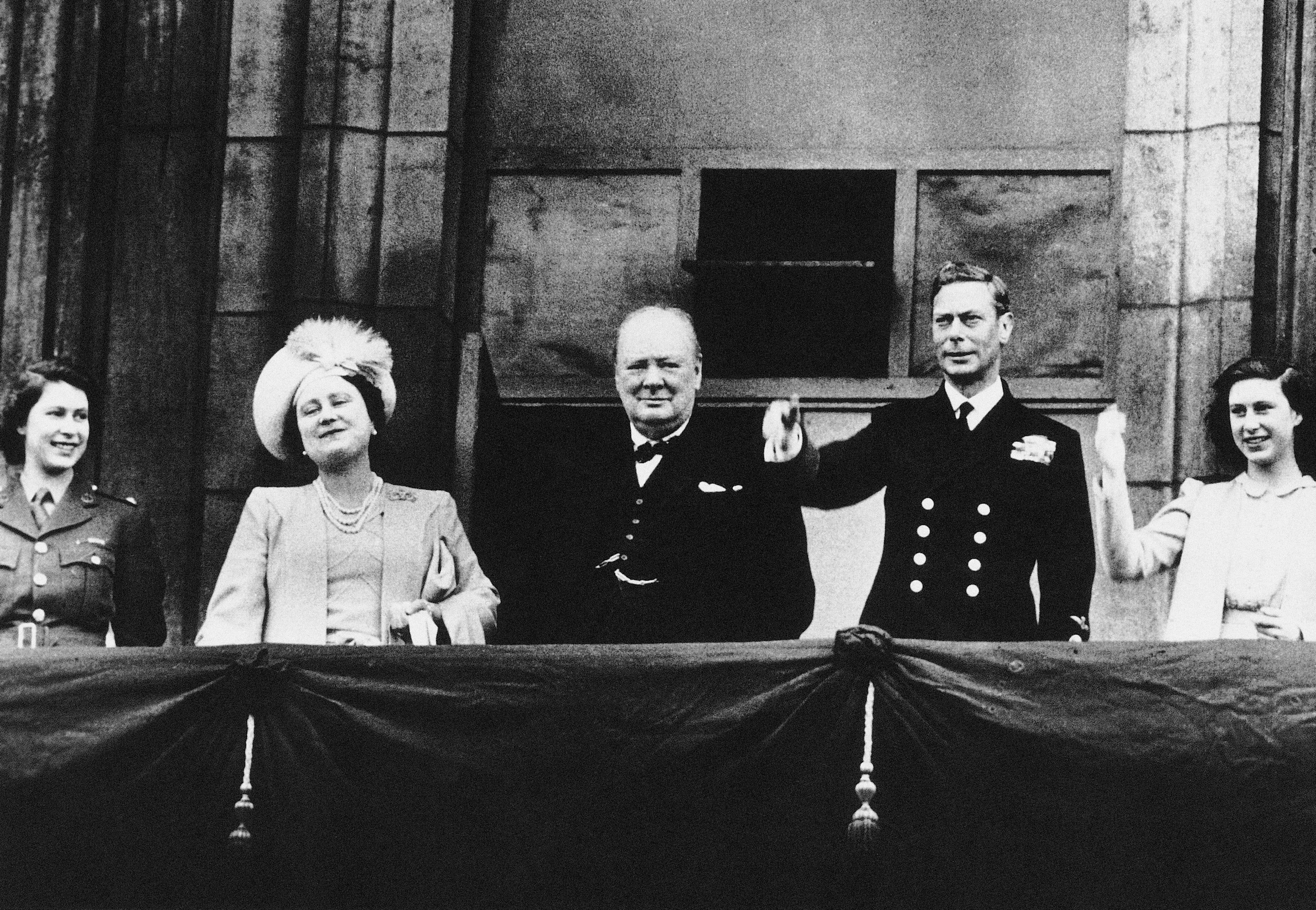 Princess Elizabeth, Queen Elizabeth the Queen Mother, Winston Churchill, King George VI and Princess Margaret on the Buckingham Palace balcony on VE Day 1945
