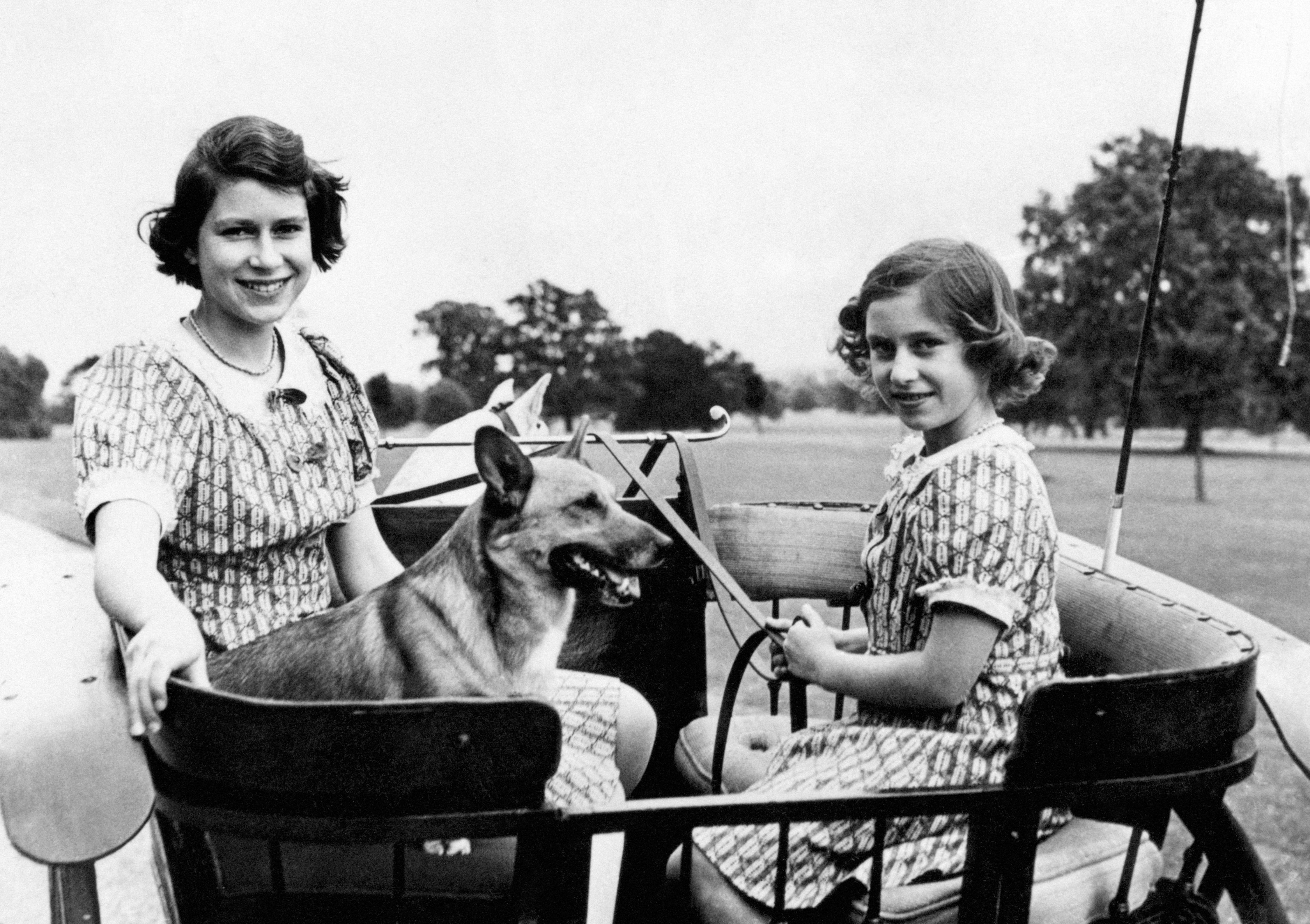 Queen Elizabeth, then Princess Elizabeth, and Princess Margaret with a dog in Windsor in 1941